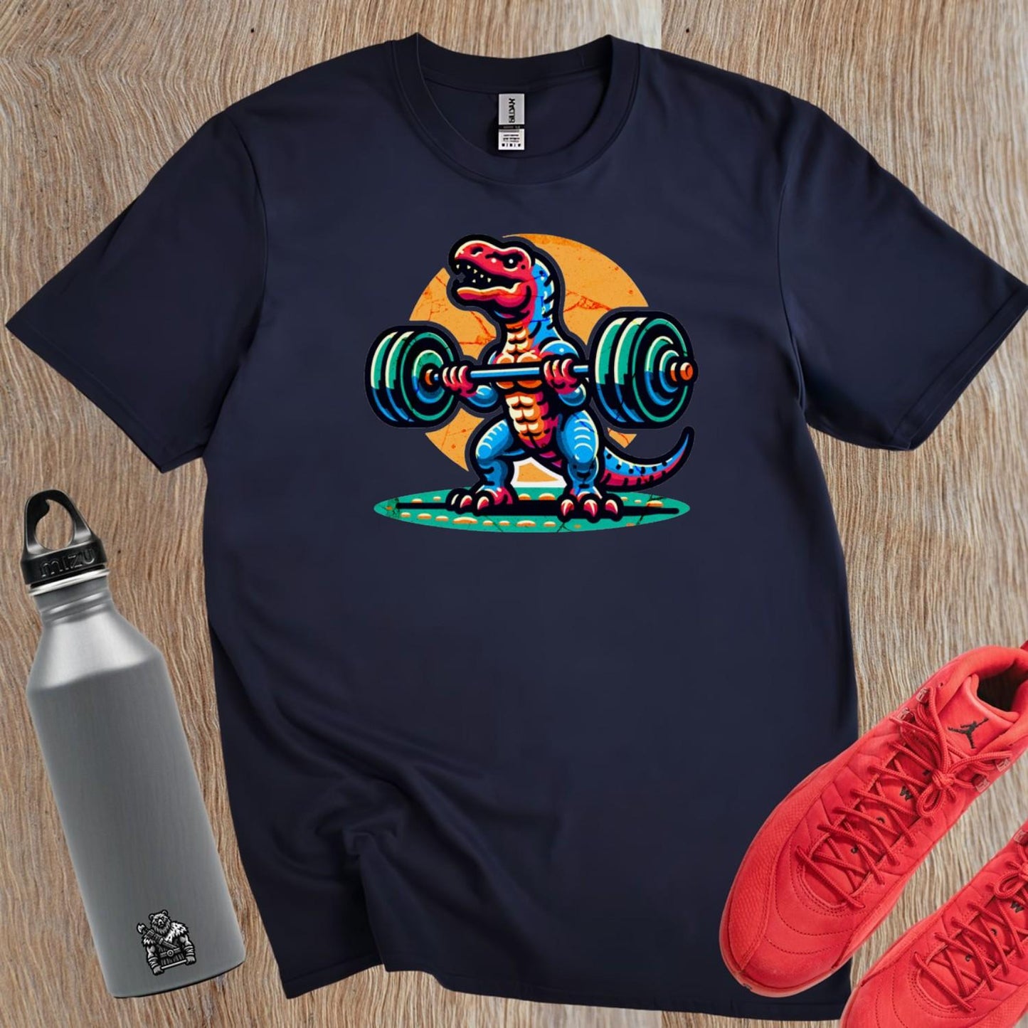 "Colorful gym T-shirt featuring a cartoon dinosaur lifting weights, perfect for fitness lovers seeking motivation and fun in workouts."