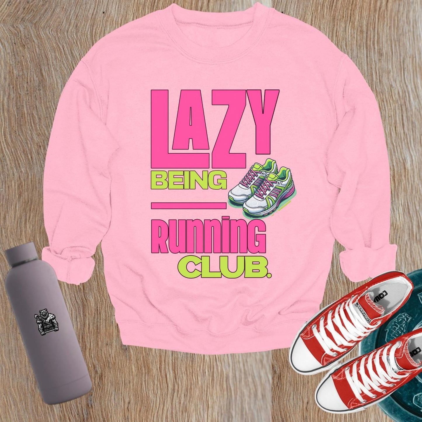 "Vibrant 'Lazy Being Running Club' sweatshirt featuring playful graphics, perfect for fitness enthusiasts and casual wearers at the gym."