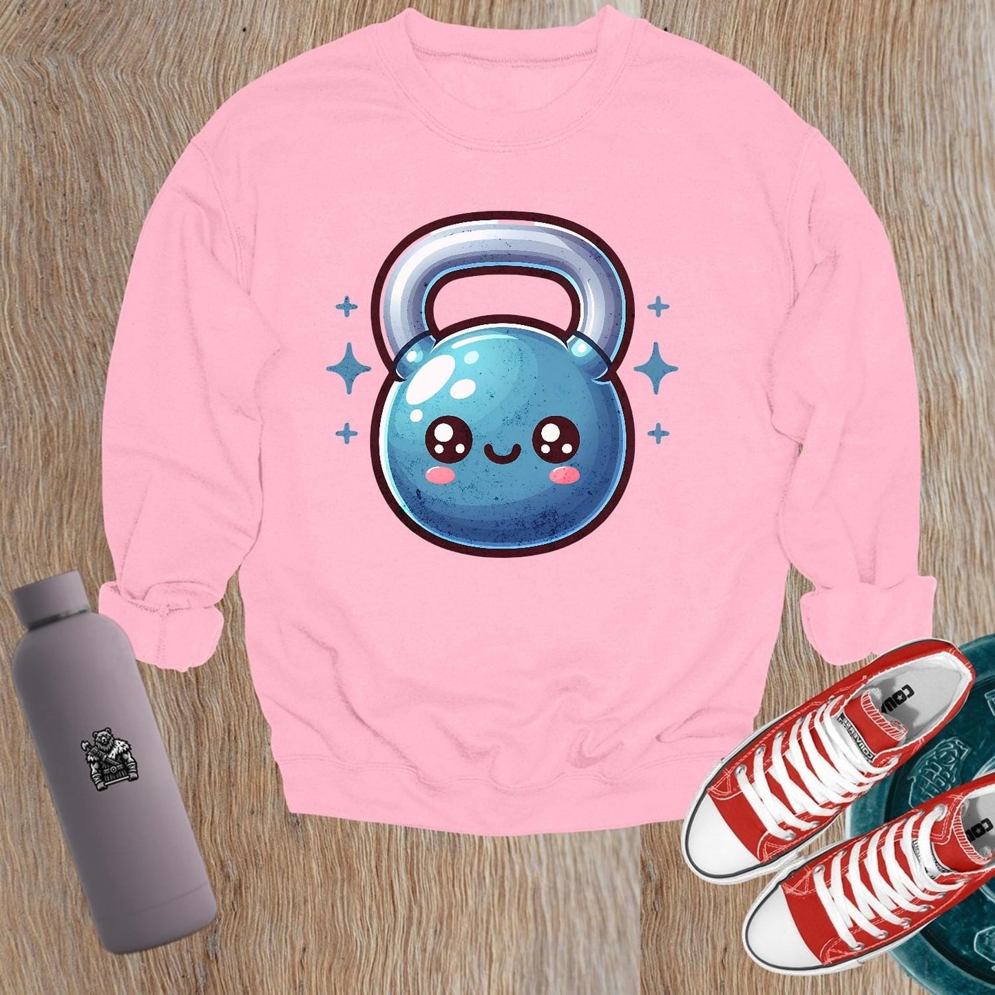 "Cozy gym sweatshirt featuring a cheerful, smiley kettlebell graphic, perfect for workouts or casual wear. Stylish and fun activewear."
