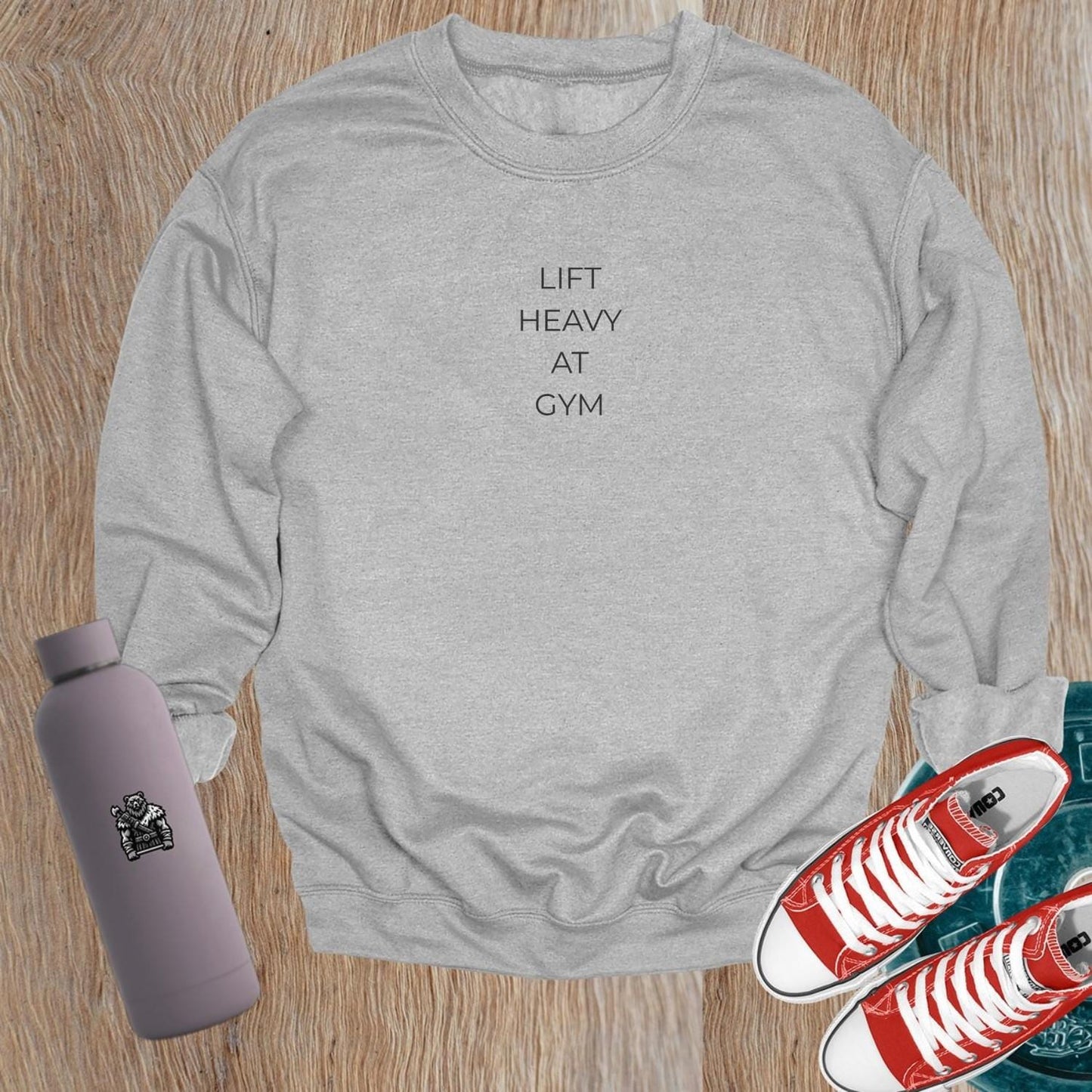 "Lift Heavy at Gym sweatshirt featuring bold lettering, designed for serious lifters, offering comfort and style for workouts."