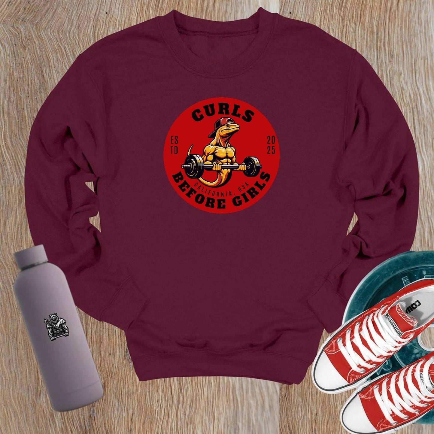 "Dark crewneck sweatshirt featuring 'Curls Before Girls' slogan, vibrant fitness mascot, perfect for workouts and casual lounging."
