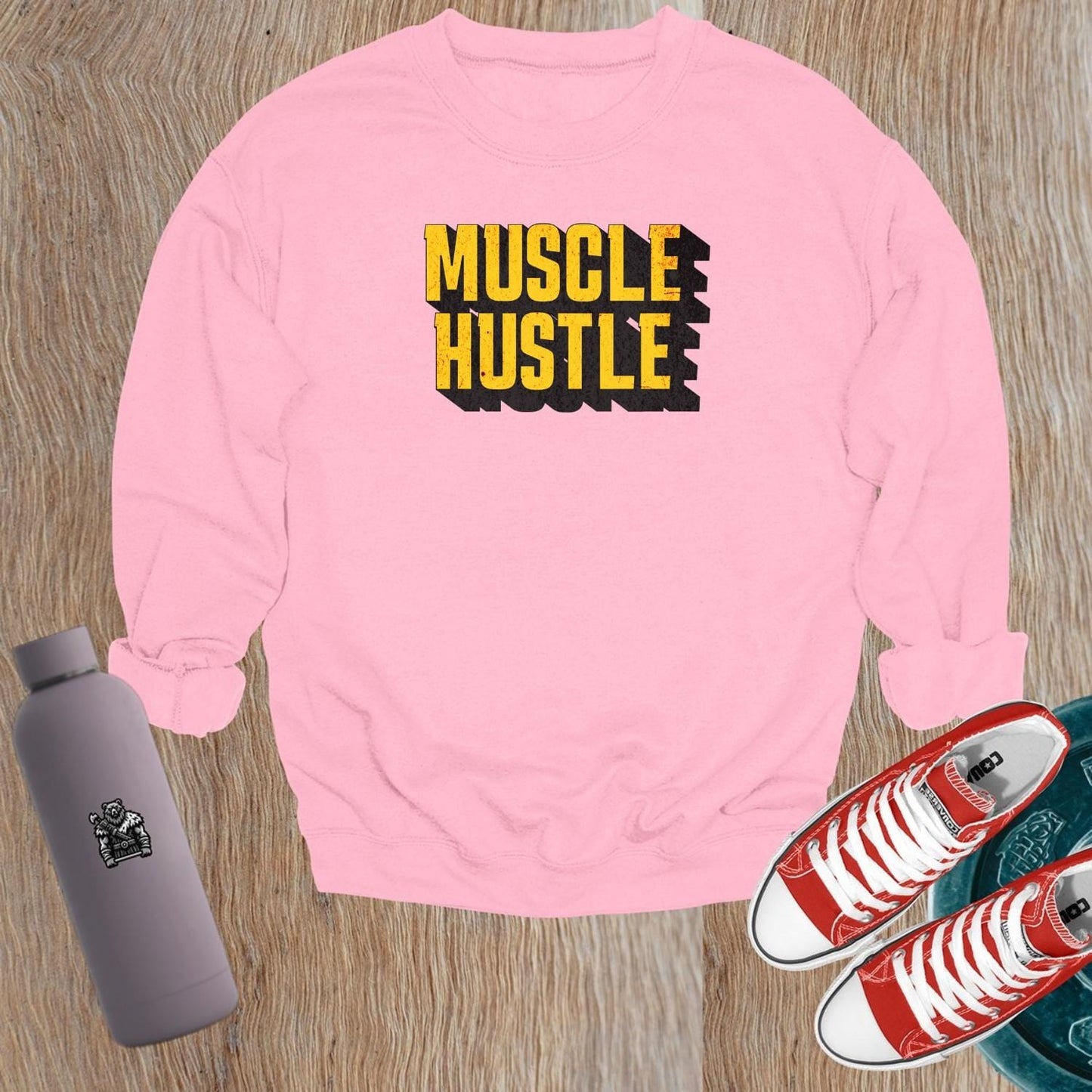 "Muscle Hustle sweatshirt featuring bold motivational graphic, designed for athletes. Perfect for workouts, errands, or lounging."