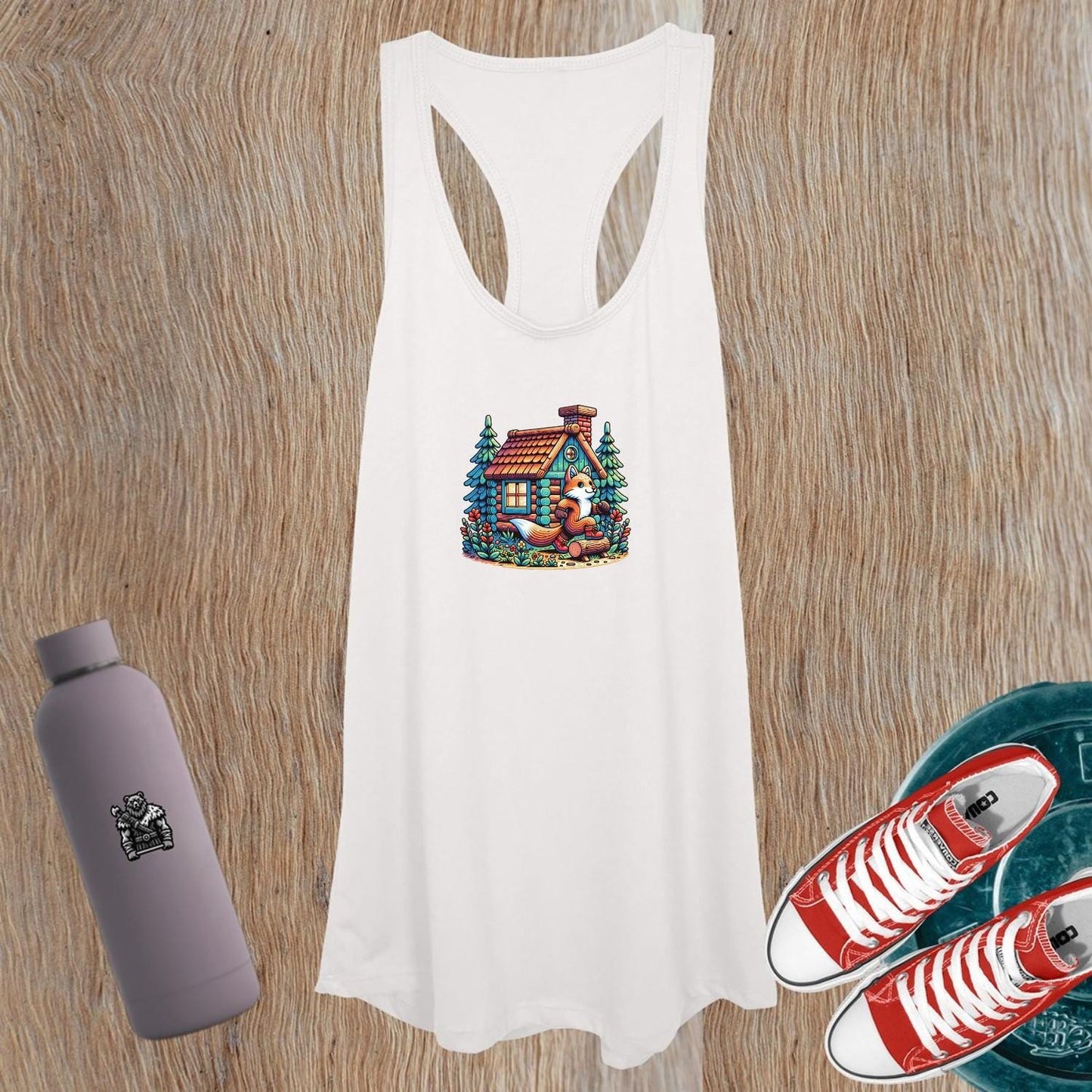 Whimsical women's tank top featuring a charming fox by a cozy cabin, perfect for gym workouts or casual outings; stylish and comfortable.