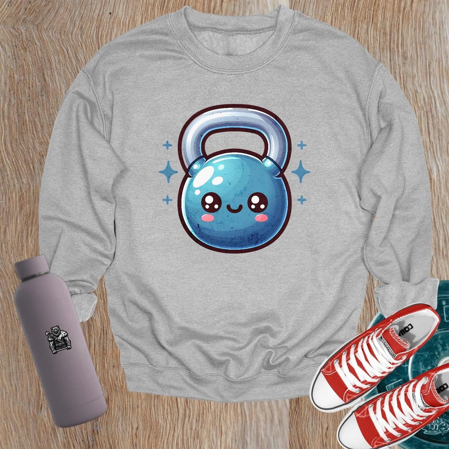 "Cozy gym sweatshirt featuring a cheerful, smiley kettlebell graphic, perfect for workouts or casual wear. Stylish and fun activewear."