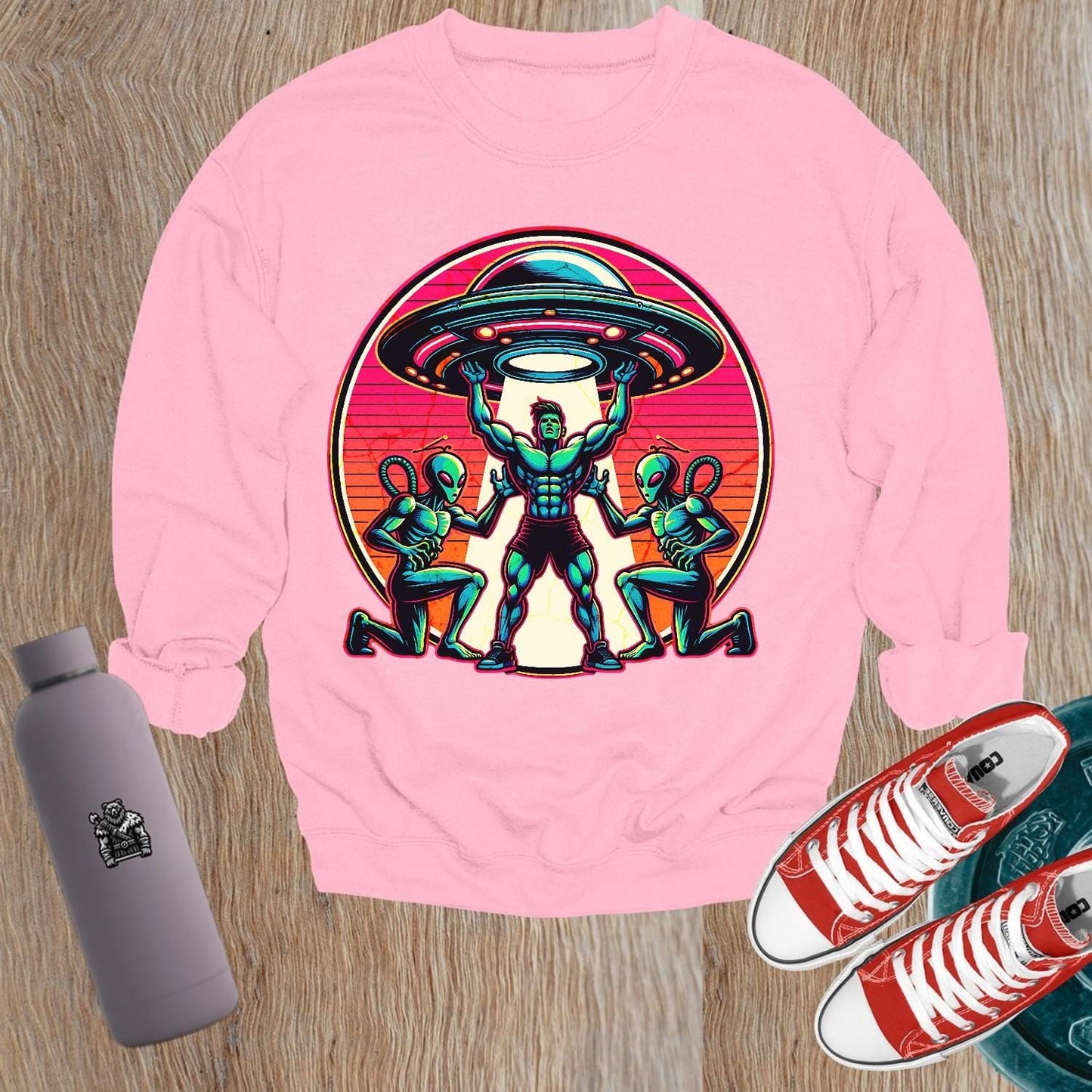 "Bold gym sweatshirt featuring a dynamic graphic of a muscular hero battling aliens, perfect for fitness enthusiasts and casual wear."