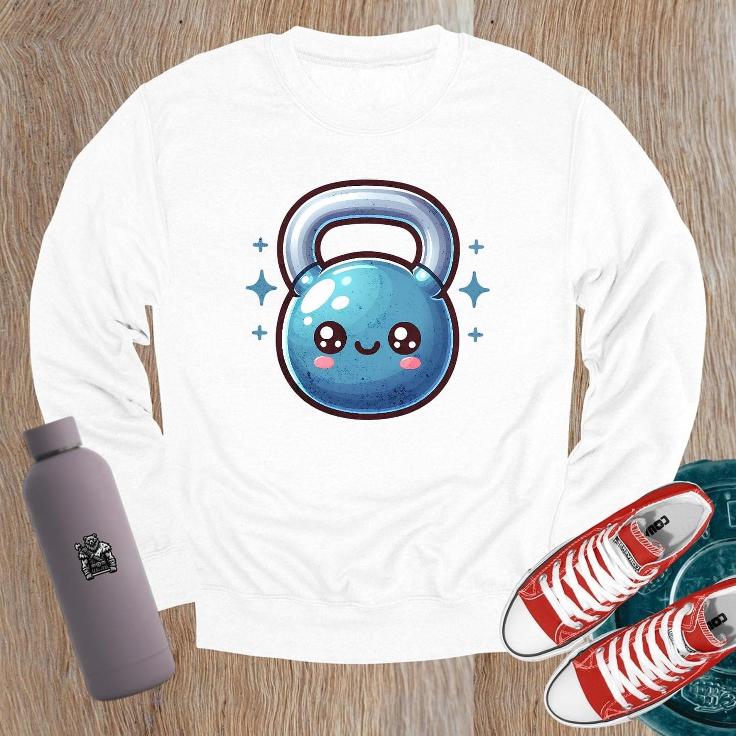 "Cozy gym sweatshirt featuring a cheerful, smiley kettlebell graphic, perfect for workouts or casual wear. Stylish and fun activewear."