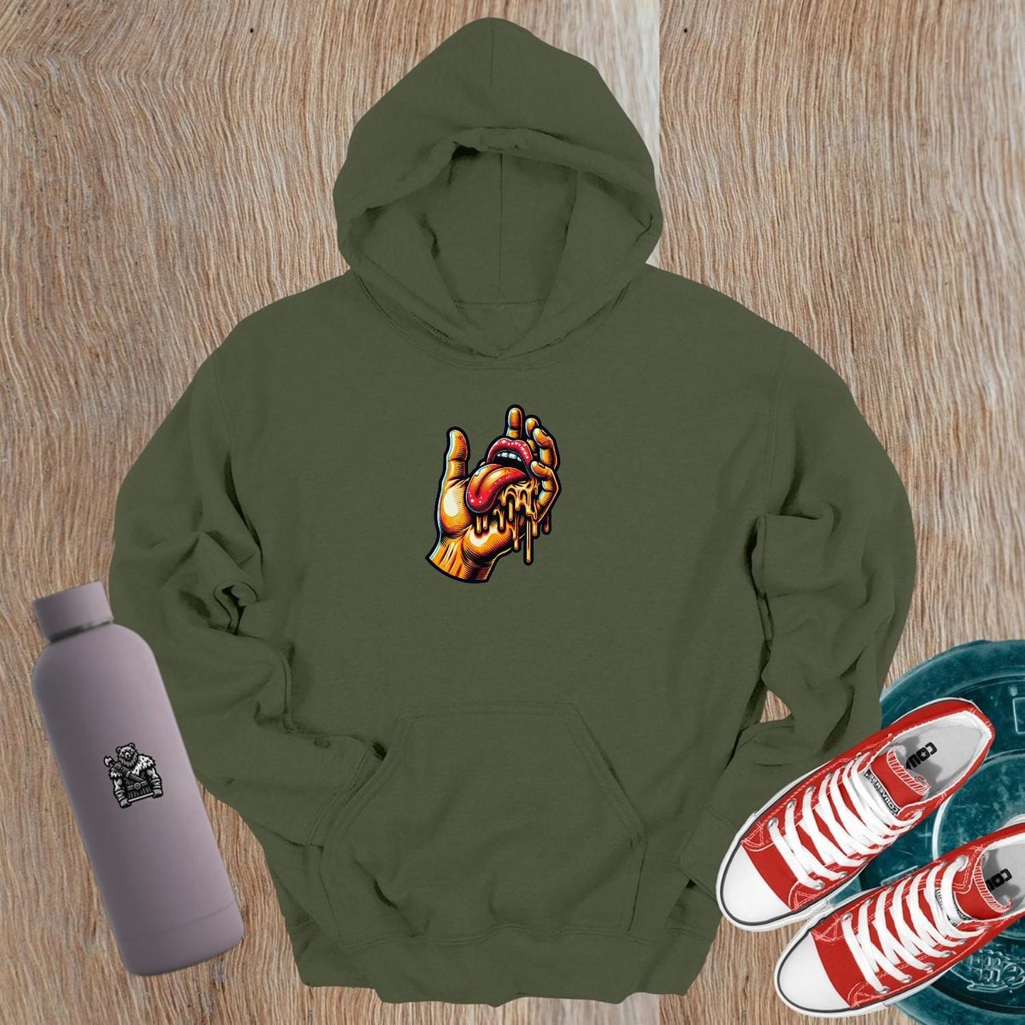 "Bold gym hoodie featuring vibrant graphic of a hand and dripping tongue, perfect for workouts and casual outings, embodying fierce style."