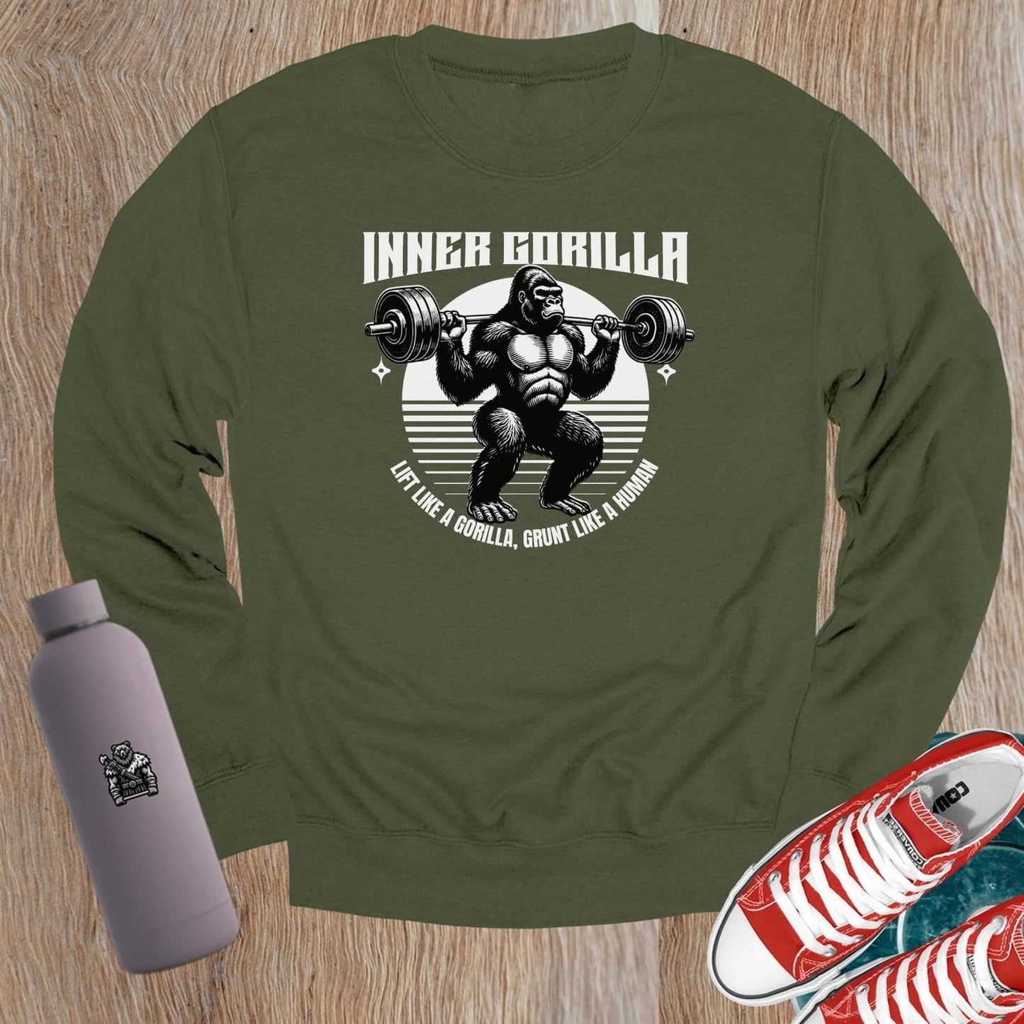 "Graphic crewneck sweatshirt featuring a powerful gorilla lifting weights with the motivational slogan 'Lift Like a Gorilla, Grunt Like a Human.' Ideal for fitness enthusiasts, this stylish gym apparel combines comfort and inspiration for workouts or casual wear."