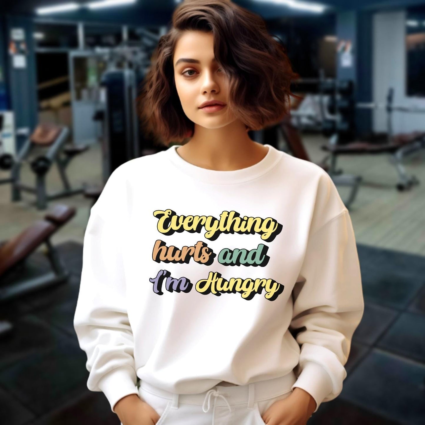 "Stylish crewneck sweatshirt featuring 'Everything hurts and I’m Hungry' slogan, perfect for gym enthusiasts embracing fitness humor."