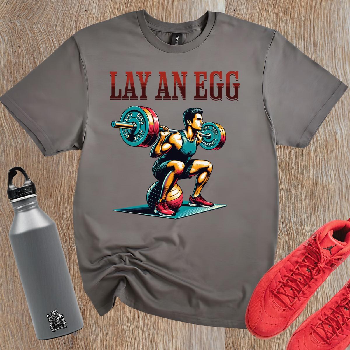 "Graphic gym T-shirt featuring 'Lay An Egg' design, showcasing humor in fitness. Ideal for workouts, casual outings, and style."