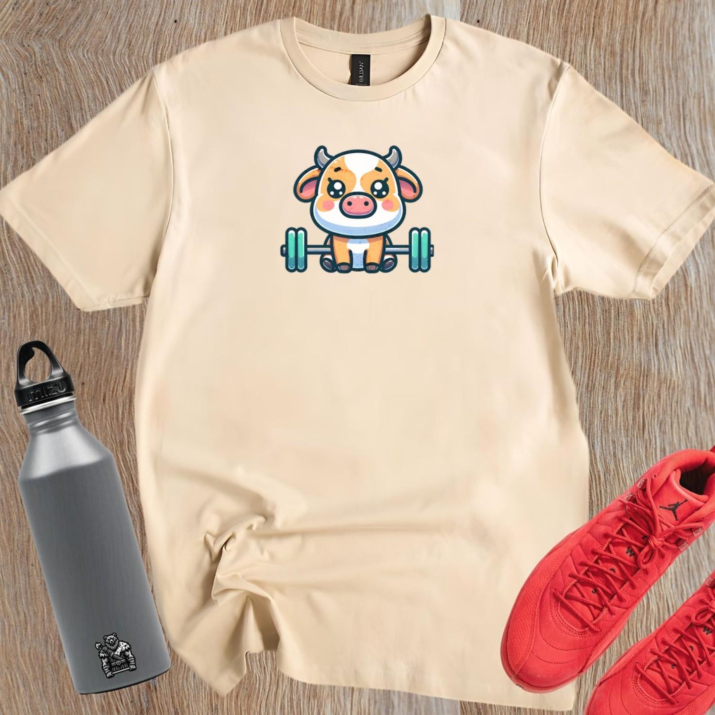 "Adorable Cow Gym T-Shirt featuring a cute cow lifting weights, perfect for fitness enthusiasts who enjoy humor and unique style."