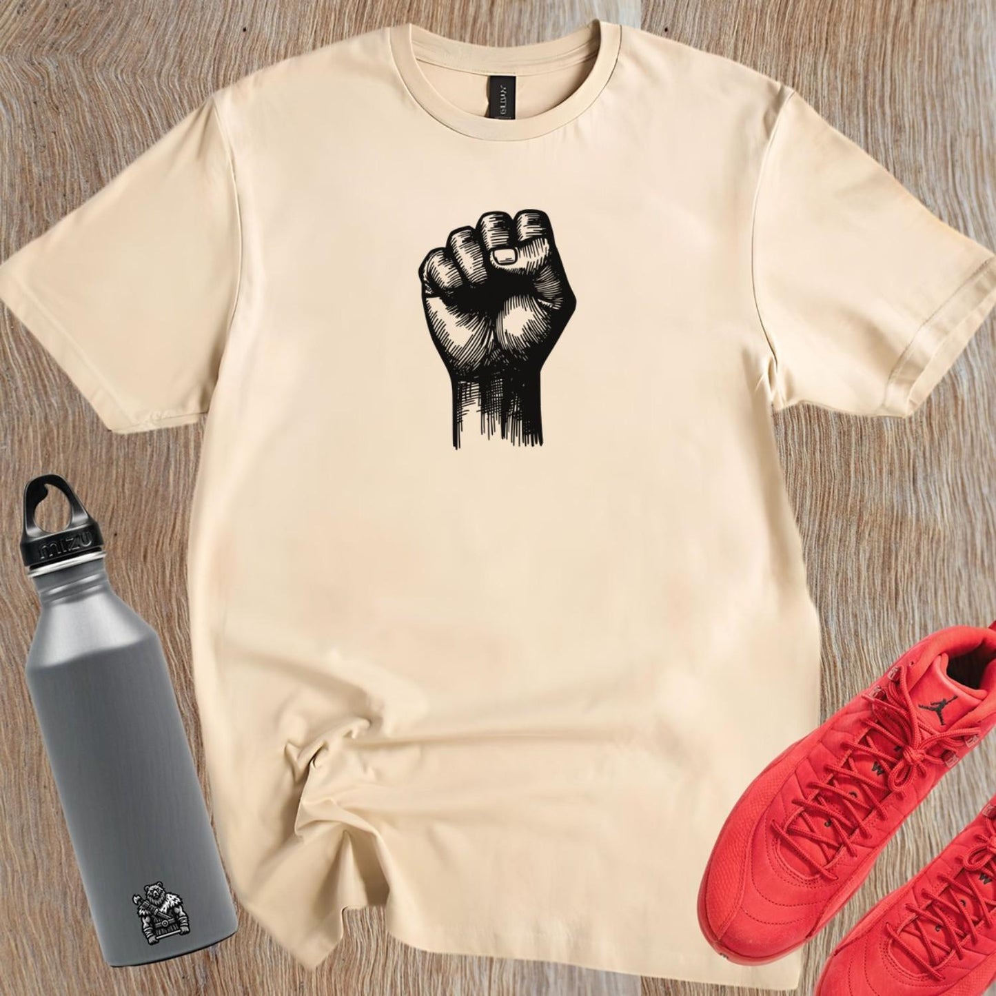 Alt text: "Bold gym t-shirt with a powerful raised fist graphic, symbolizing strength and determination for passionate fitness enthusiasts."