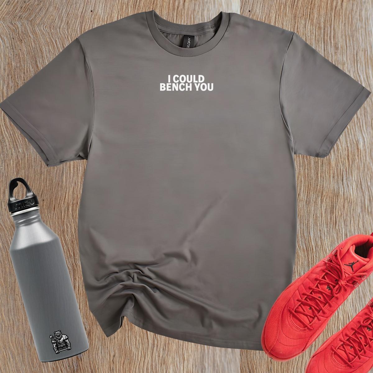 Alt text: "Bold fitness T-shirt featuring 'I Could Bench You' slogan, ideal for gym enthusiasts who lift with confidence and style."