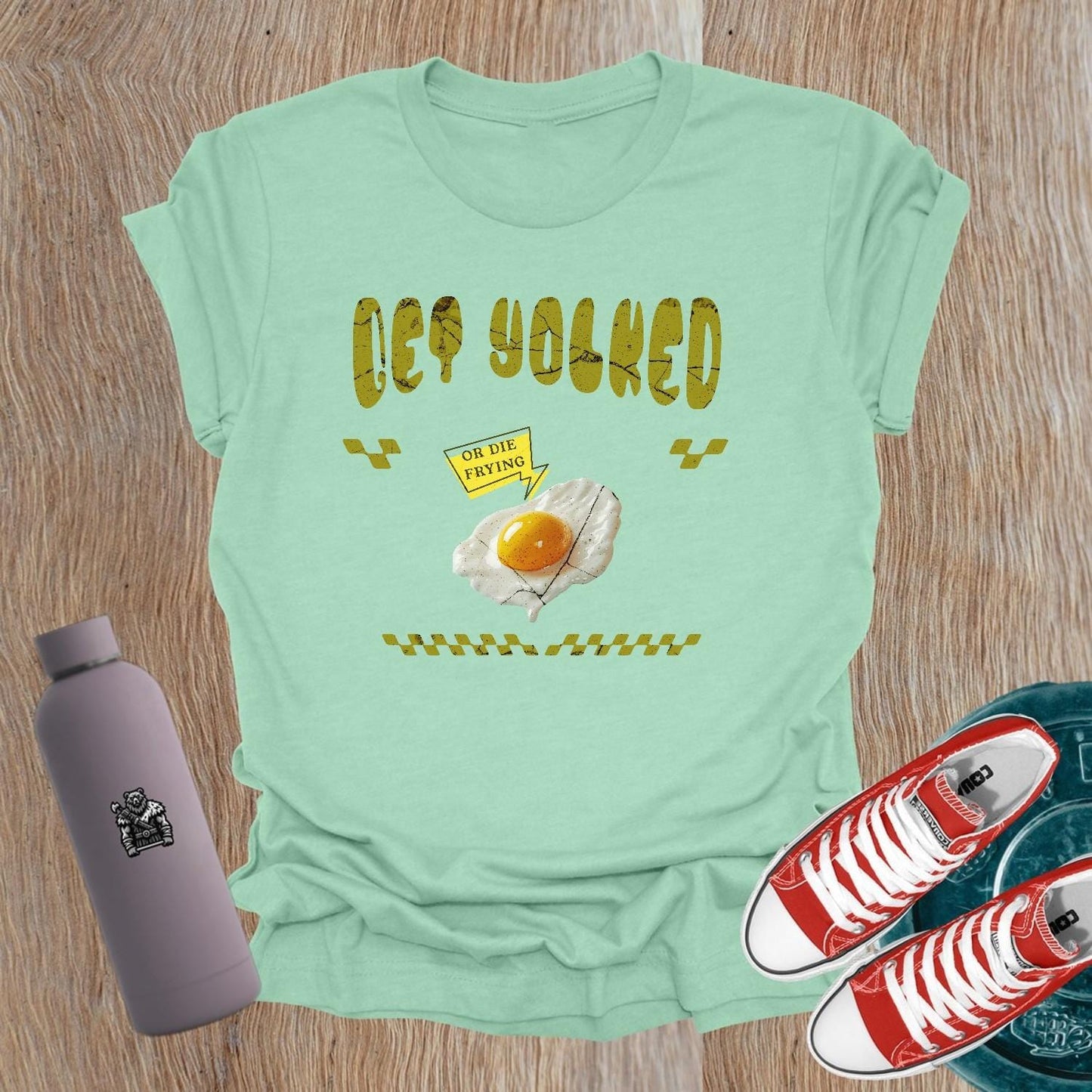 "Graphic T-shirt for women showcasing 'Get Yolked' slogan, featuring a weightlifting design, perfect for fitness enthusiasts and gym lovers."