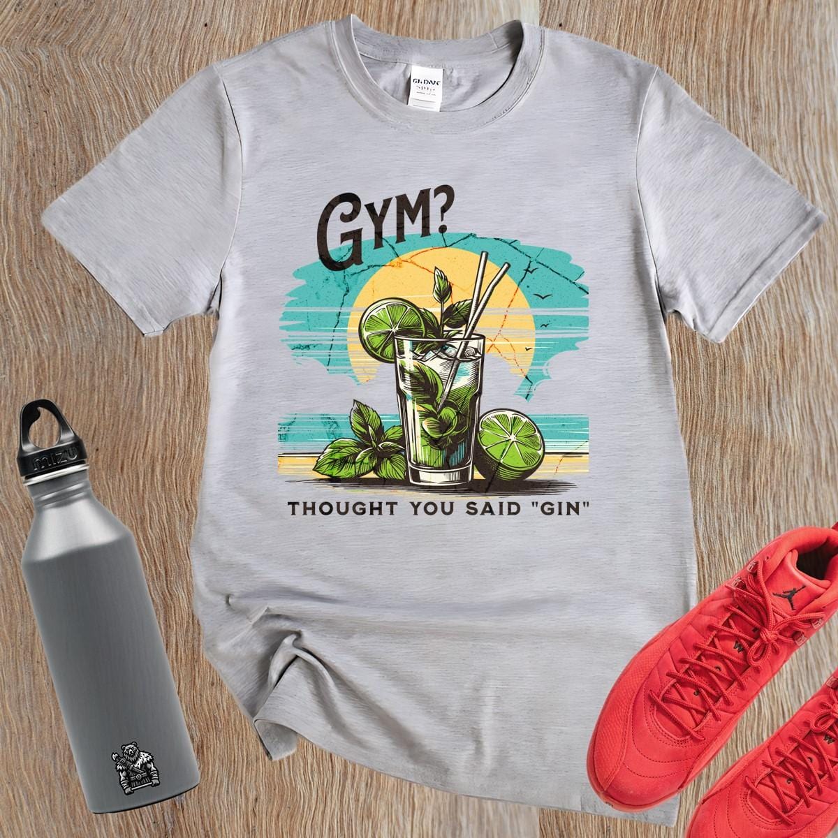 Alt text: "Fun graphic T-shirt featuring the humorous phrase 'GYM? I Thought You Said 'GIN'!' Perfect for fitness lovers and gym enthusiasts."