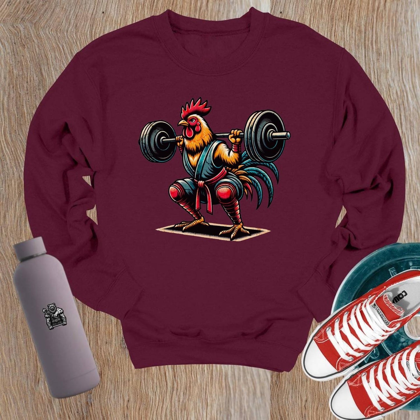 "Fierce weightlifting rooster graphic on a stylish crewneck sweatshirt, perfect for gym enthusiasts. Bold design boosts workout motivation."