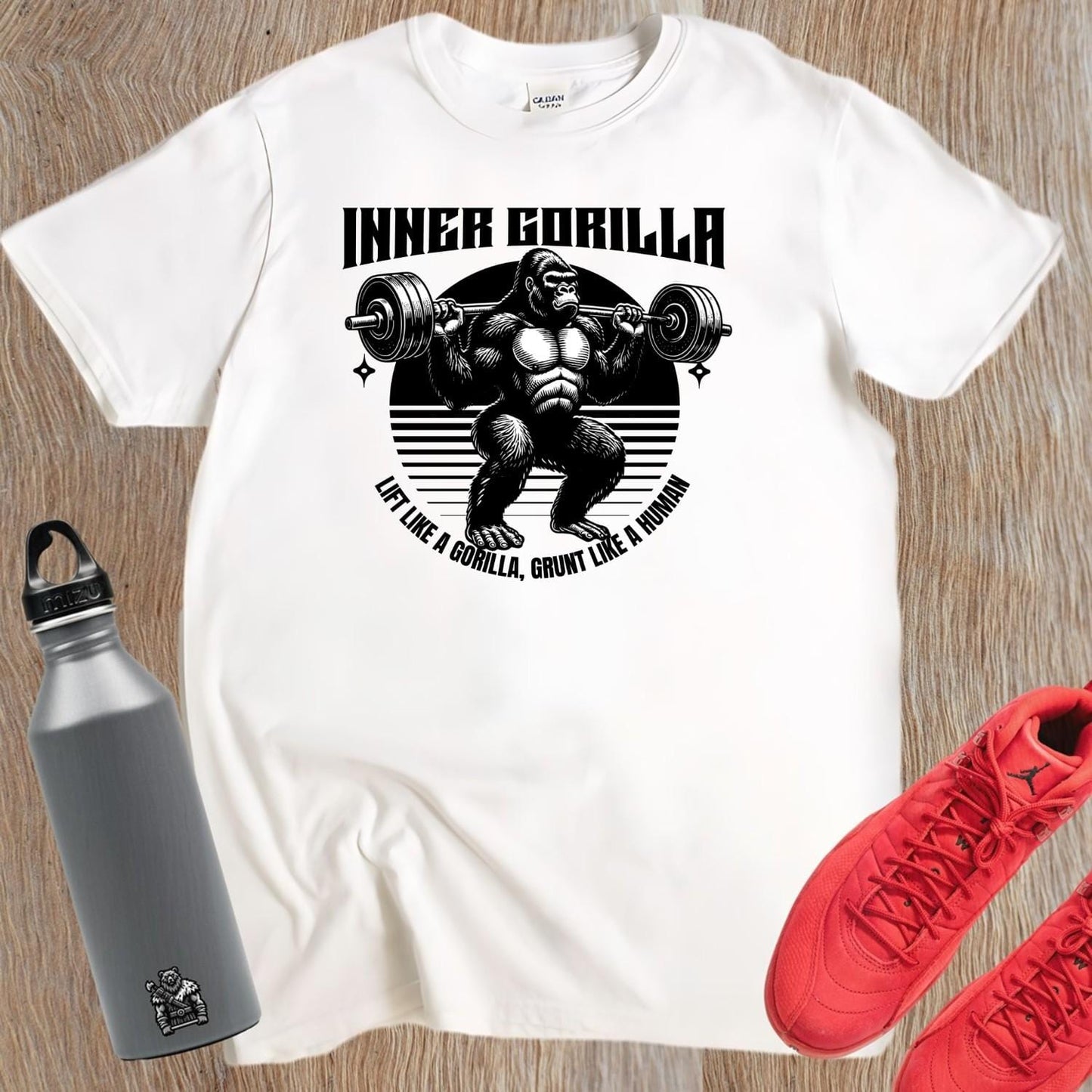Alt text: "Gorilla Gym T-Shirt featuring a bold graphic of a powerful gorilla lifting weights, symbolizing strength and fitness motivation."