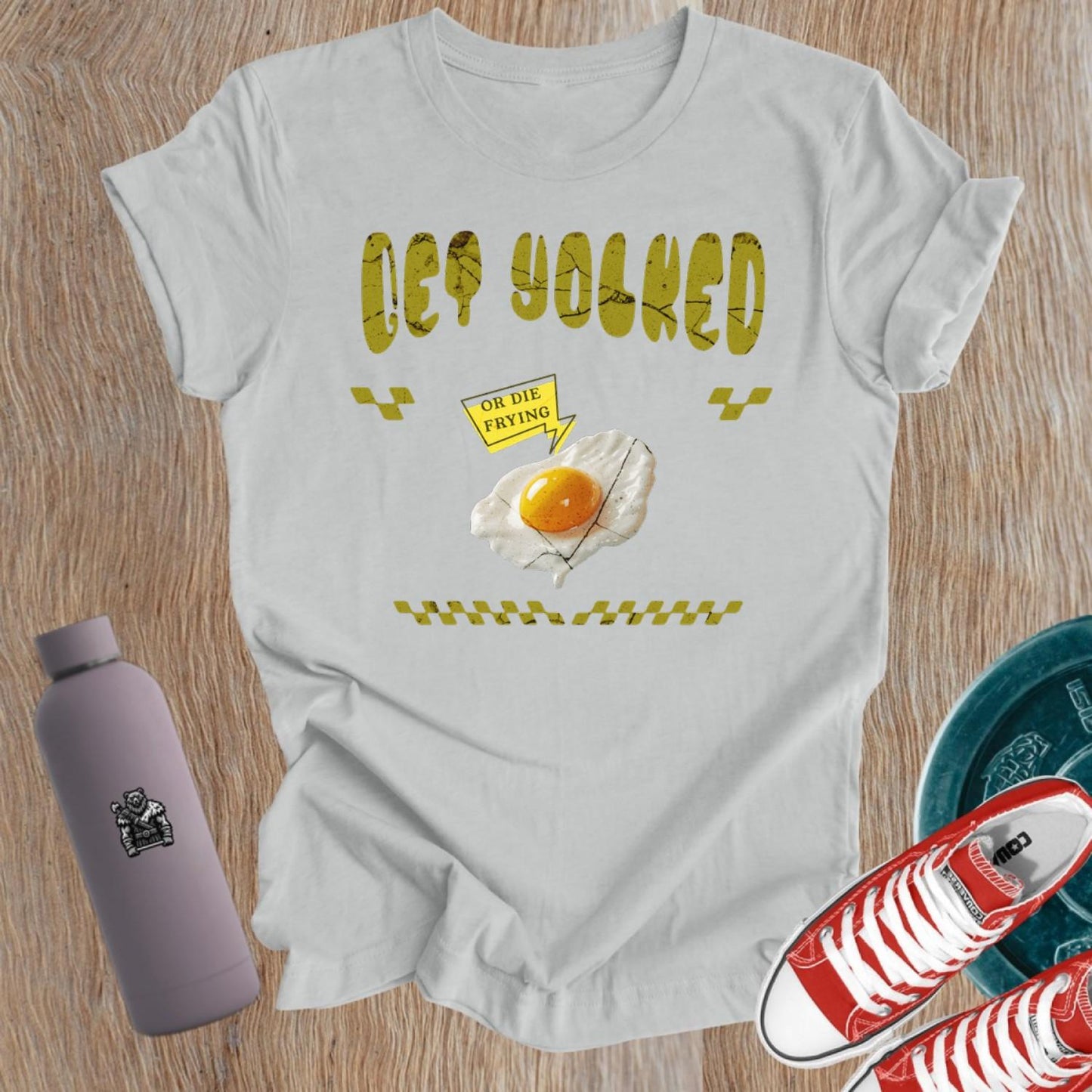"Graphic T-shirt for women showcasing 'Get Yolked' slogan, featuring a weightlifting design, perfect for fitness enthusiasts and gym lovers."