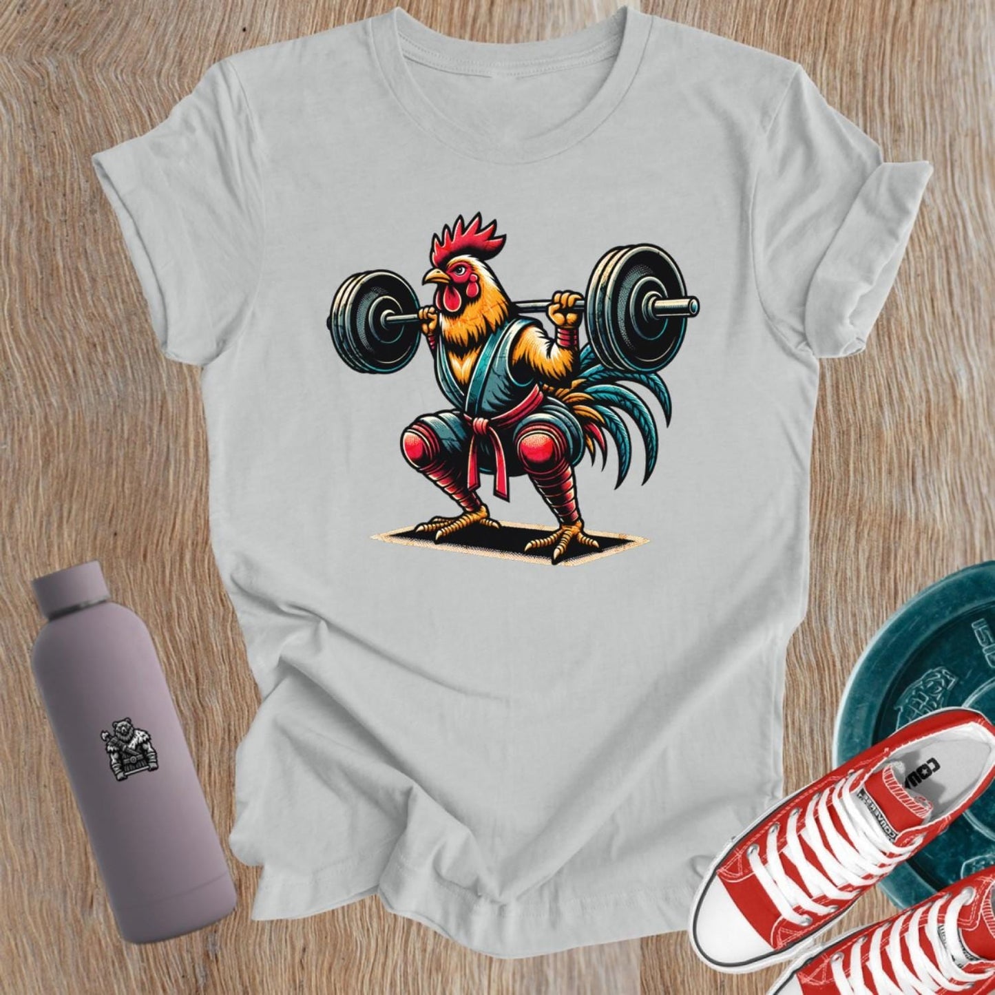 Bold gym T-shirt featuring a fiercely squatting rooster, symbolizing empowerment and determination for women who lift weights.