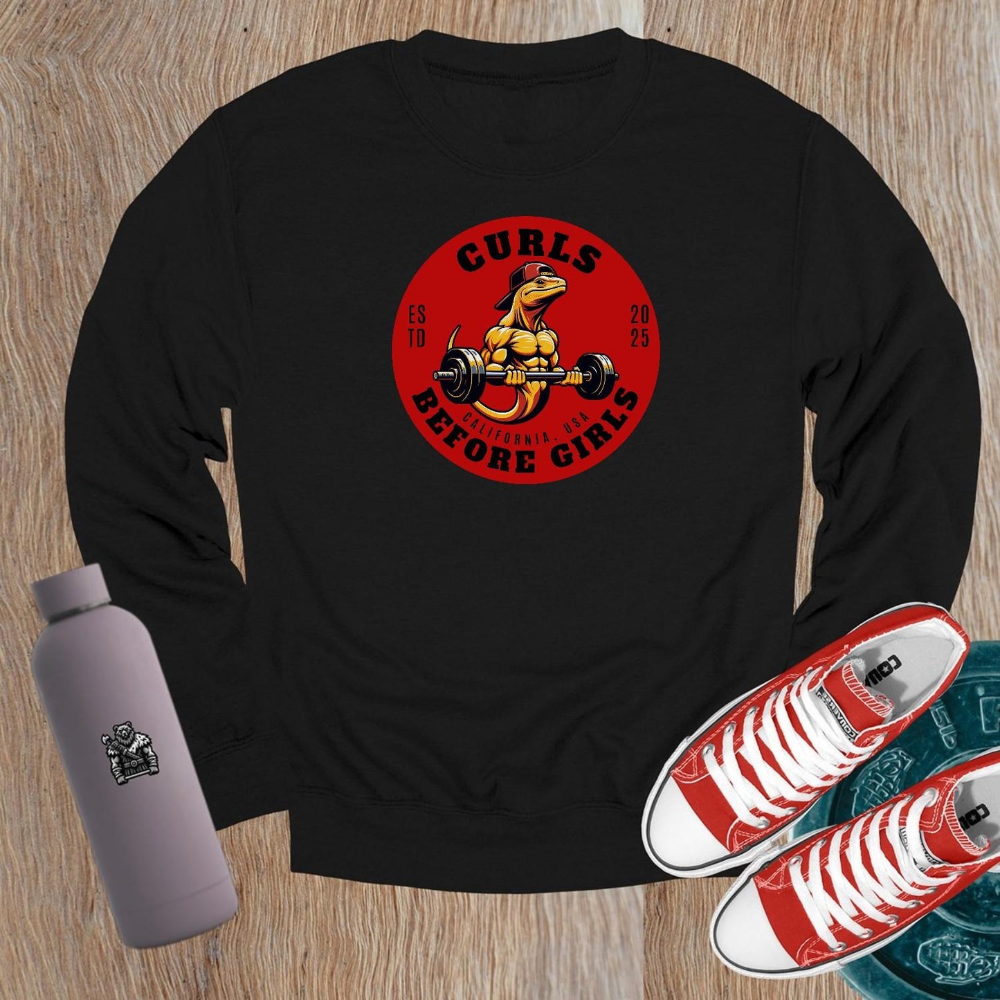 "Dark crewneck sweatshirt featuring 'Curls Before Girls' slogan, vibrant fitness mascot, perfect for workouts and casual lounging."