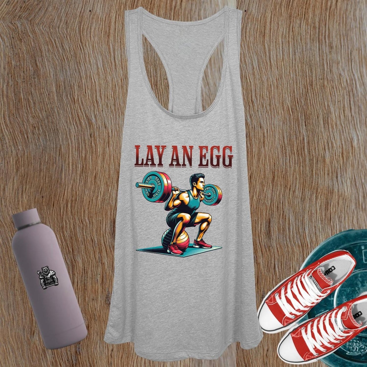 "Women’s tank top featuring bold 'Lay An Egg' design, perfect for workouts or casual wear, showcasing fitness style and confidence."
