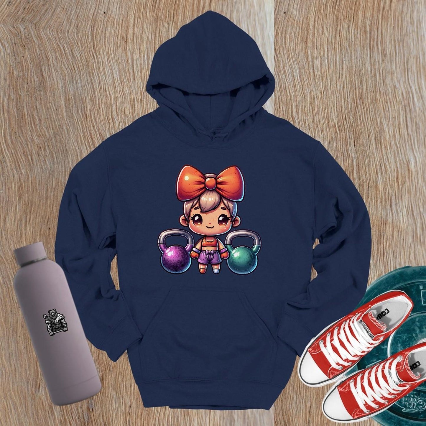 "Vibrant gym hoodie featuring a playful character lifting kettlebells, perfect blend of style and function for workouts and casual wear."