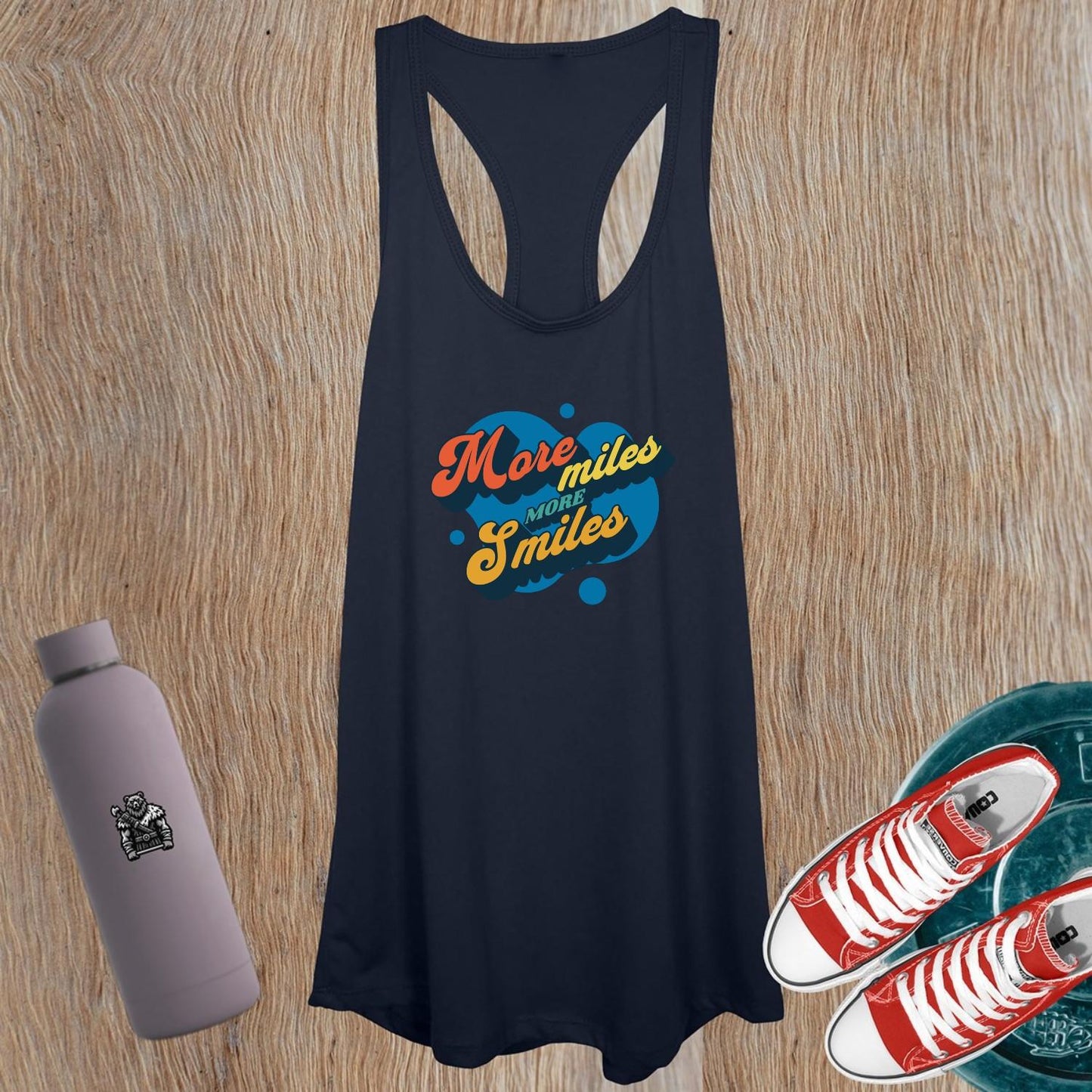 "Vibrant women's gym tank top featuring 'More Miles, More Smiles' motto, perfect for workouts and casual outings. Stylish design."