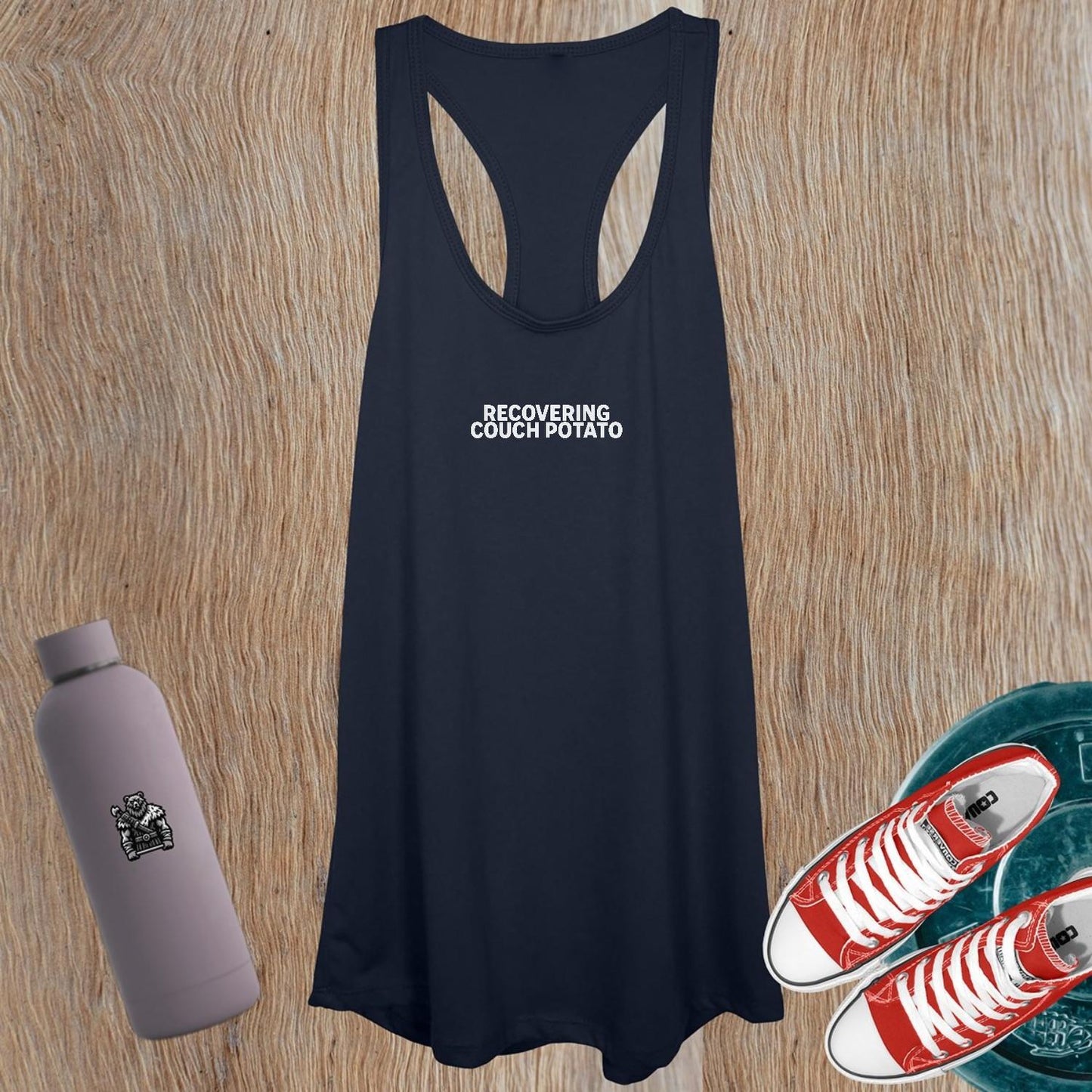Alt text: "Women's workout tank top featuring 'Recovering Couch Potato' graphic, relaxed fit, ideal for gym or lounging, promoting fitness journey."