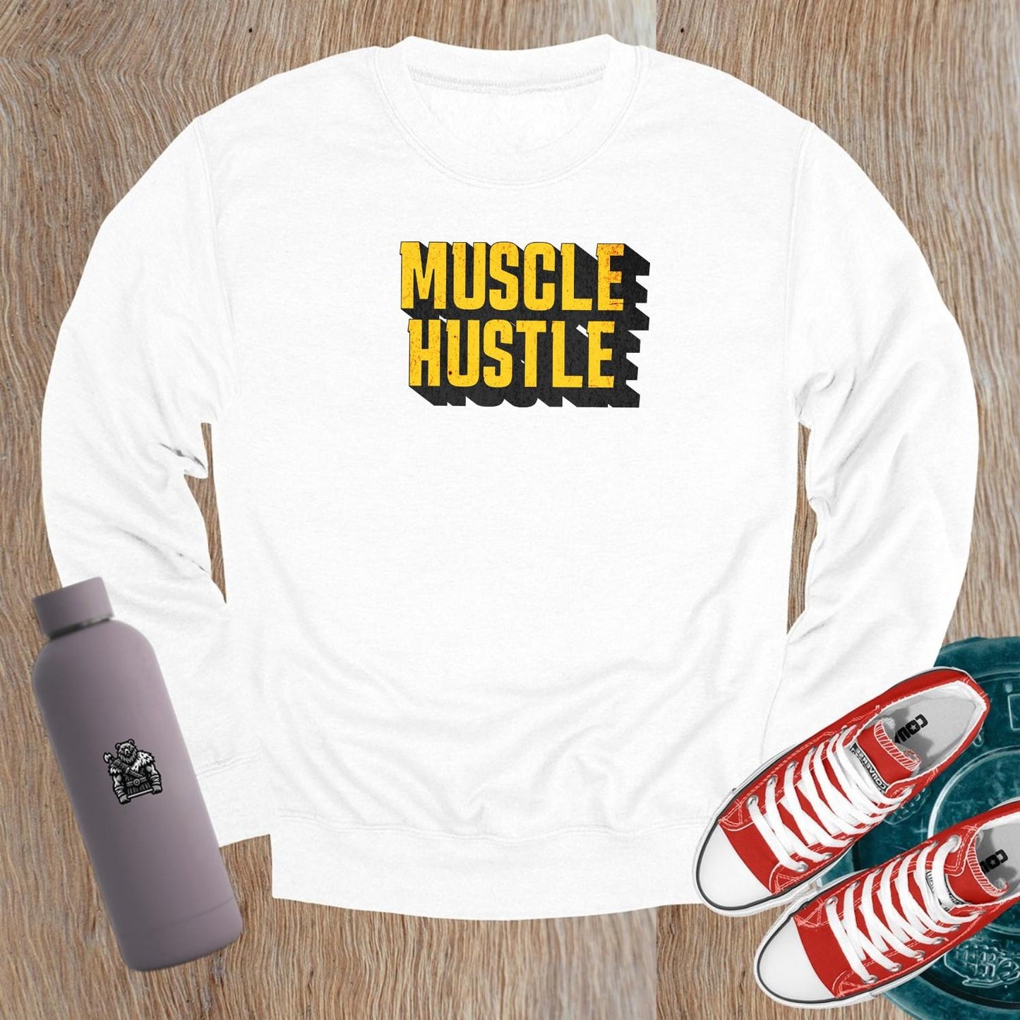 "Muscle Hustle sweatshirt featuring bold motivational graphic, designed for athletes. Perfect for workouts, errands, or lounging."