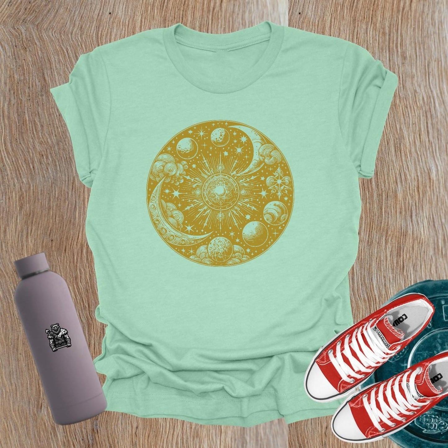 "Women's celestial design gym tee featuring strength symbols, perfect for weightlifting and activewear, blending flair with functionality."
