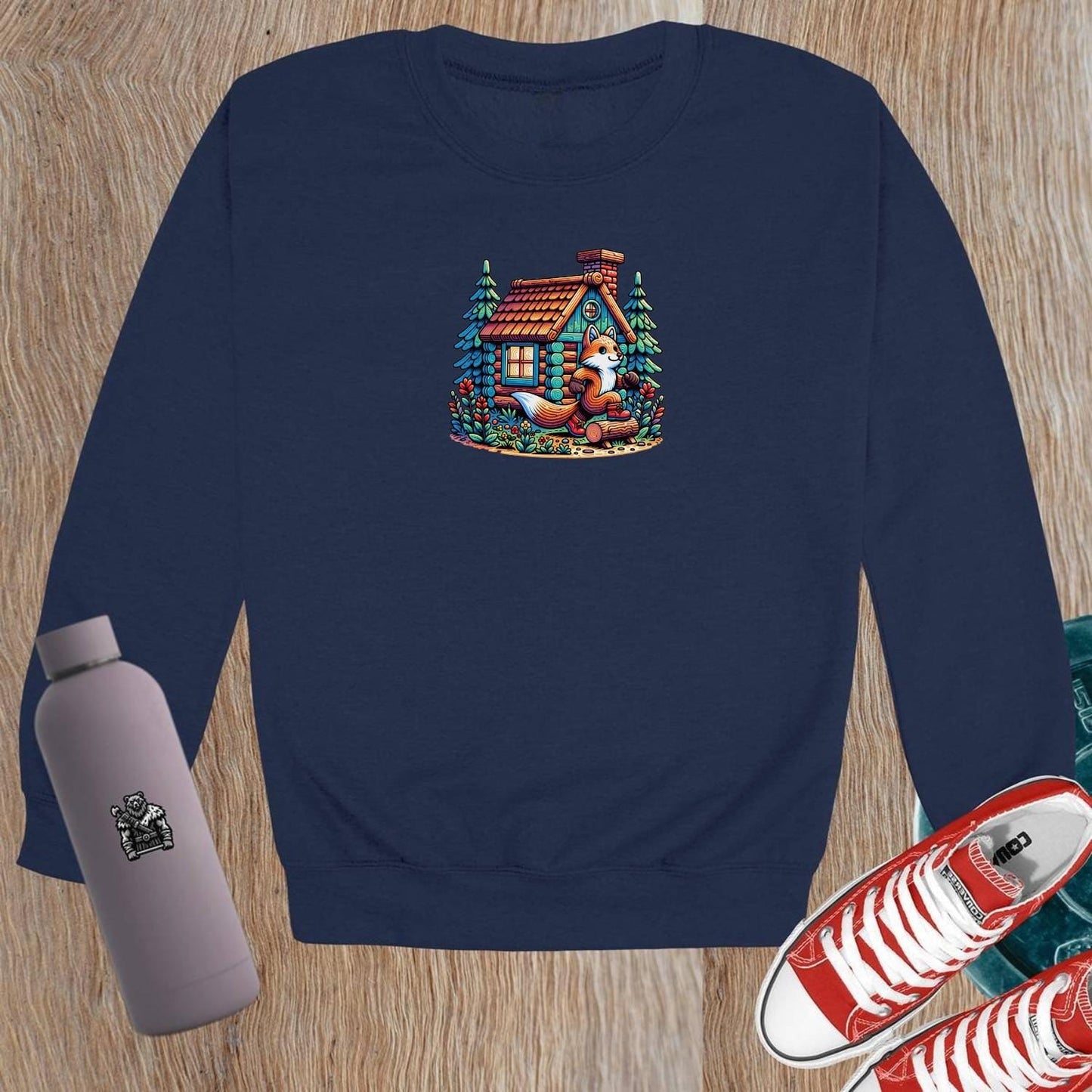 "Cozy crewneck sweatshirt featuring a playful fox beside a charming log cabin, perfect for gym workouts or casual lounging."