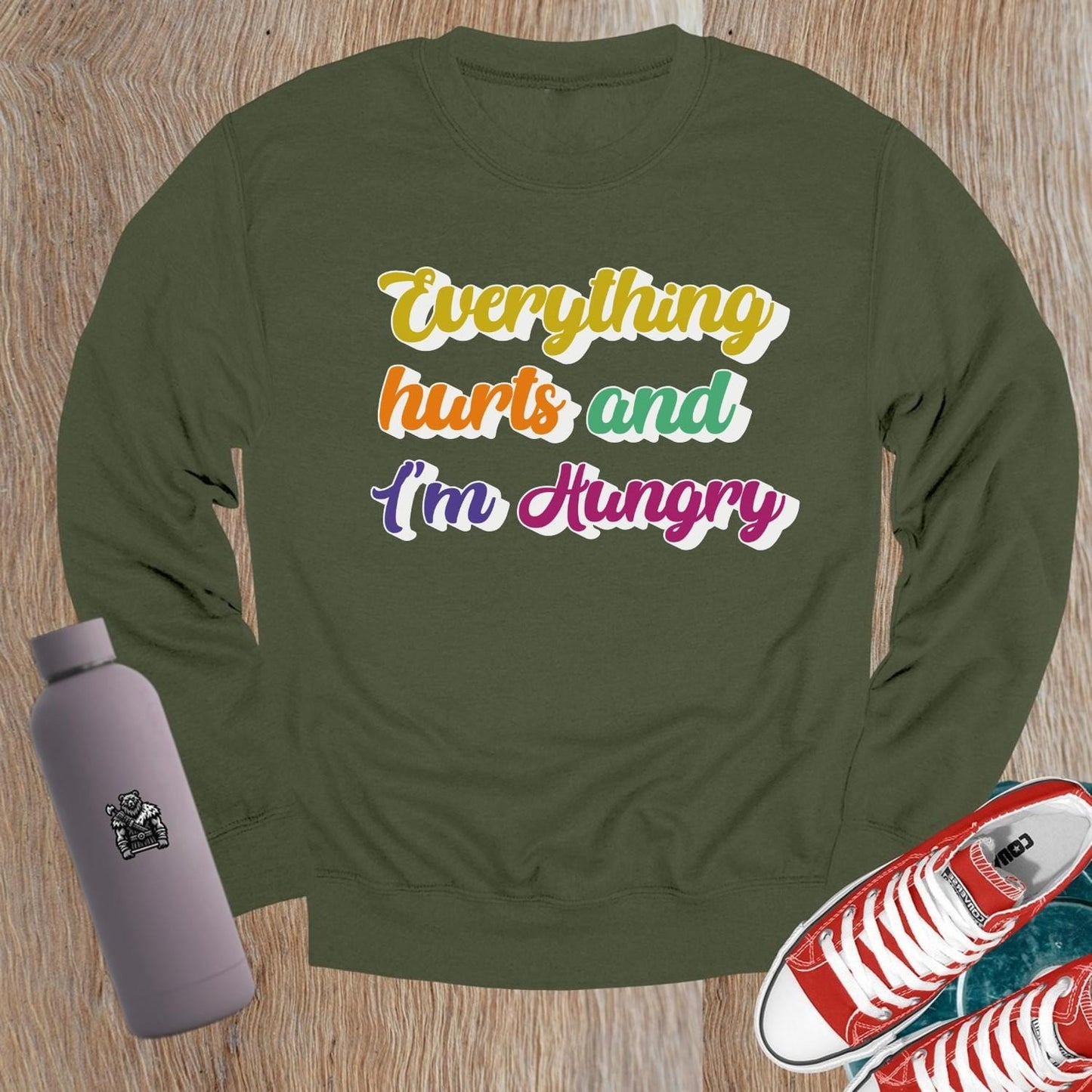 "Bold Crewneck Sweatshirt for gym-goers, featuring 'Everything hurts and I’m Hungry' in eye-catching design, perfect for workouts."