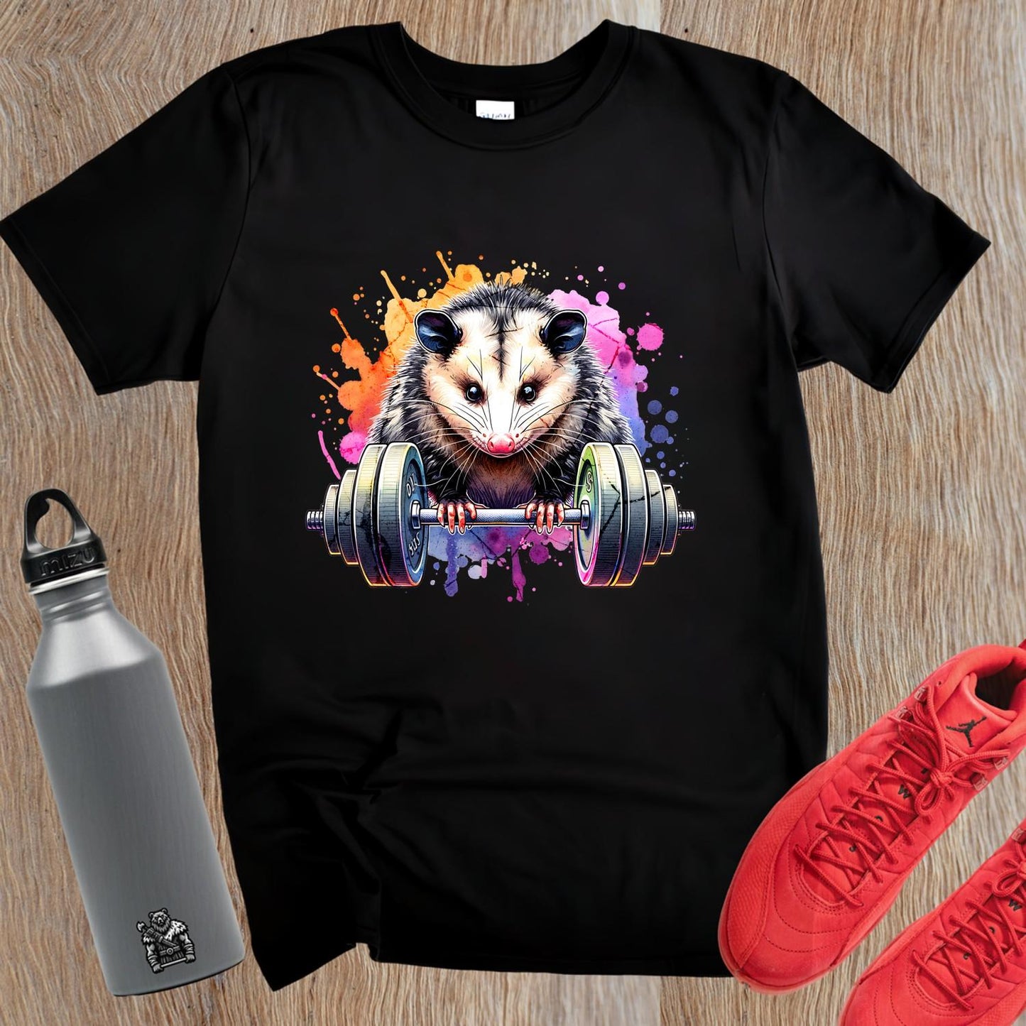 "Vibrant gym T-shirt featuring a playful opossum lifting weights, blending fitness and fun, perfect for workout enthusiasts."