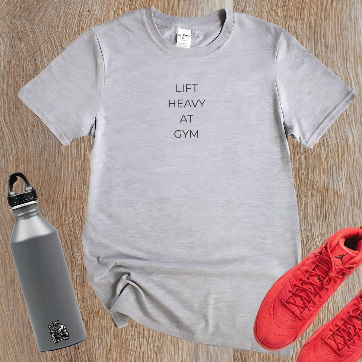"Bold 'Lift Heavy at Gym' T-shirt for fitness enthusiasts featuring motivational text, perfect for workouts and casual wear."