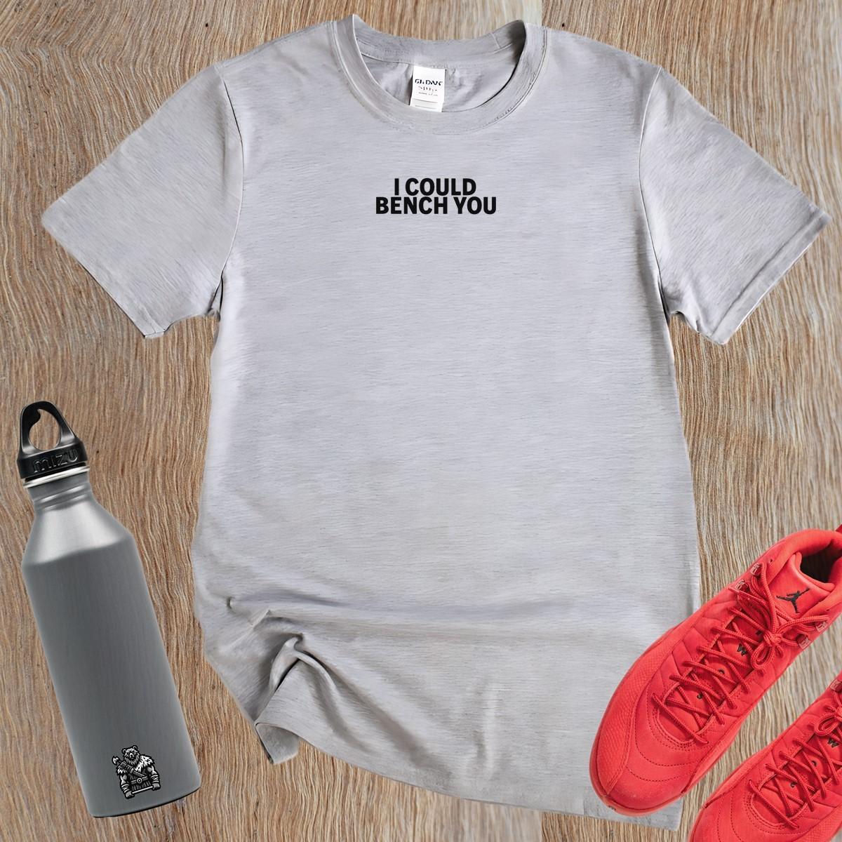 "Bold gym T-shirt with playful 'I Could Bench You' phrase, designed for active wear. Perfect for weightlifting and cardio workouts."