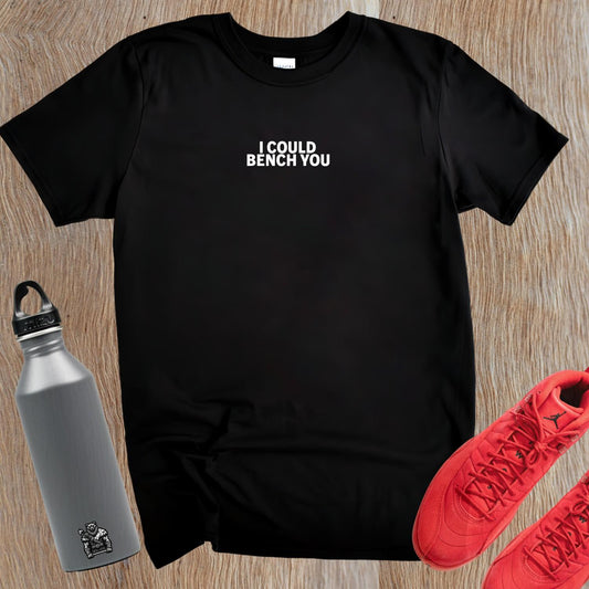 Alt text: "Bold fitness T-shirt featuring 'I Could Bench You' slogan, ideal for gym enthusiasts who lift with confidence and style."