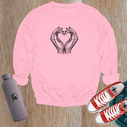 "Stylish gym sweatshirt featuring a heart formed by hands, perfect for fitness lovers. Comfortable, trendy activewear for workouts."