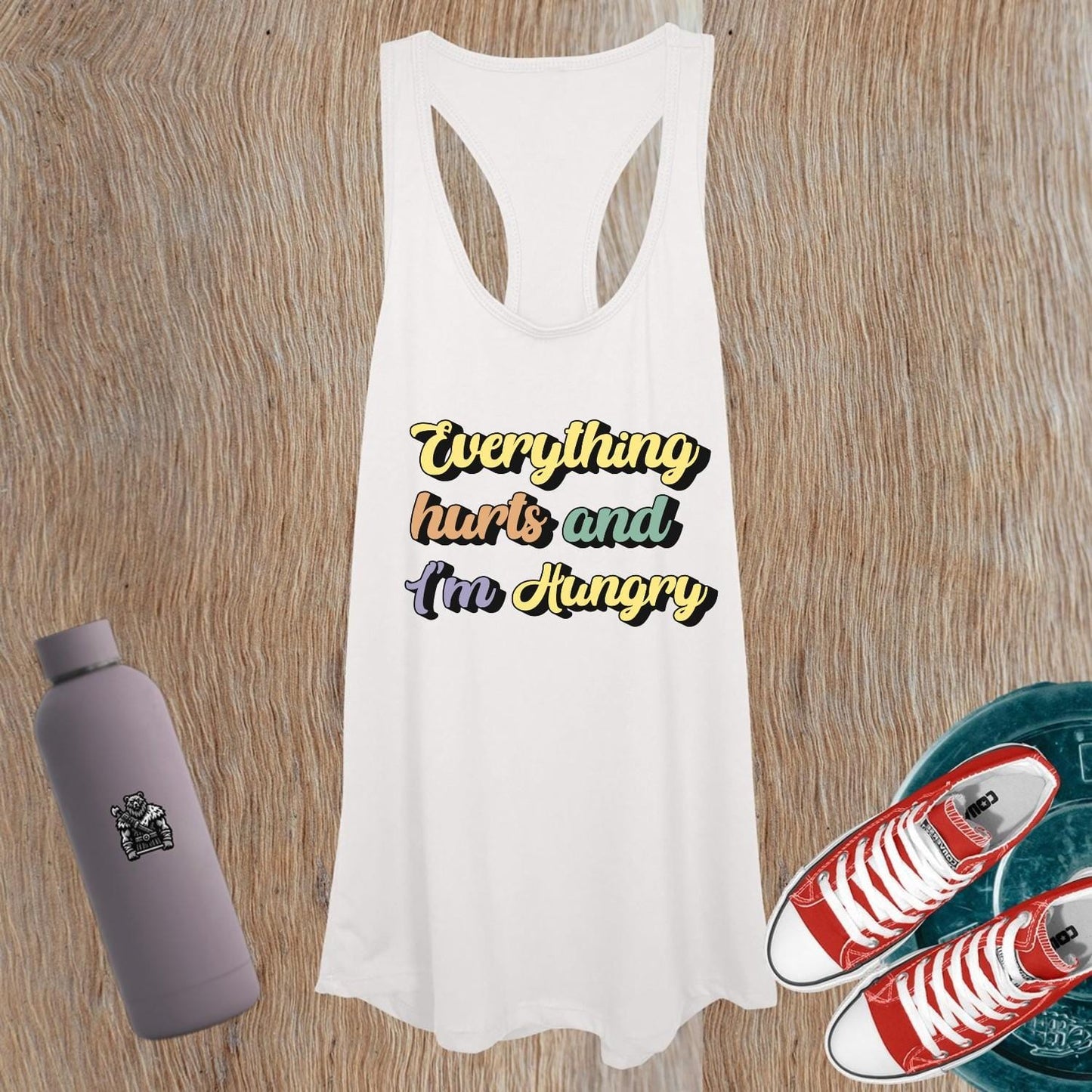 "Women's gym tank top featuring playful phrase 'Everything hurts and I’m Hungry', perfect for fitness enthusiasts and workouts."