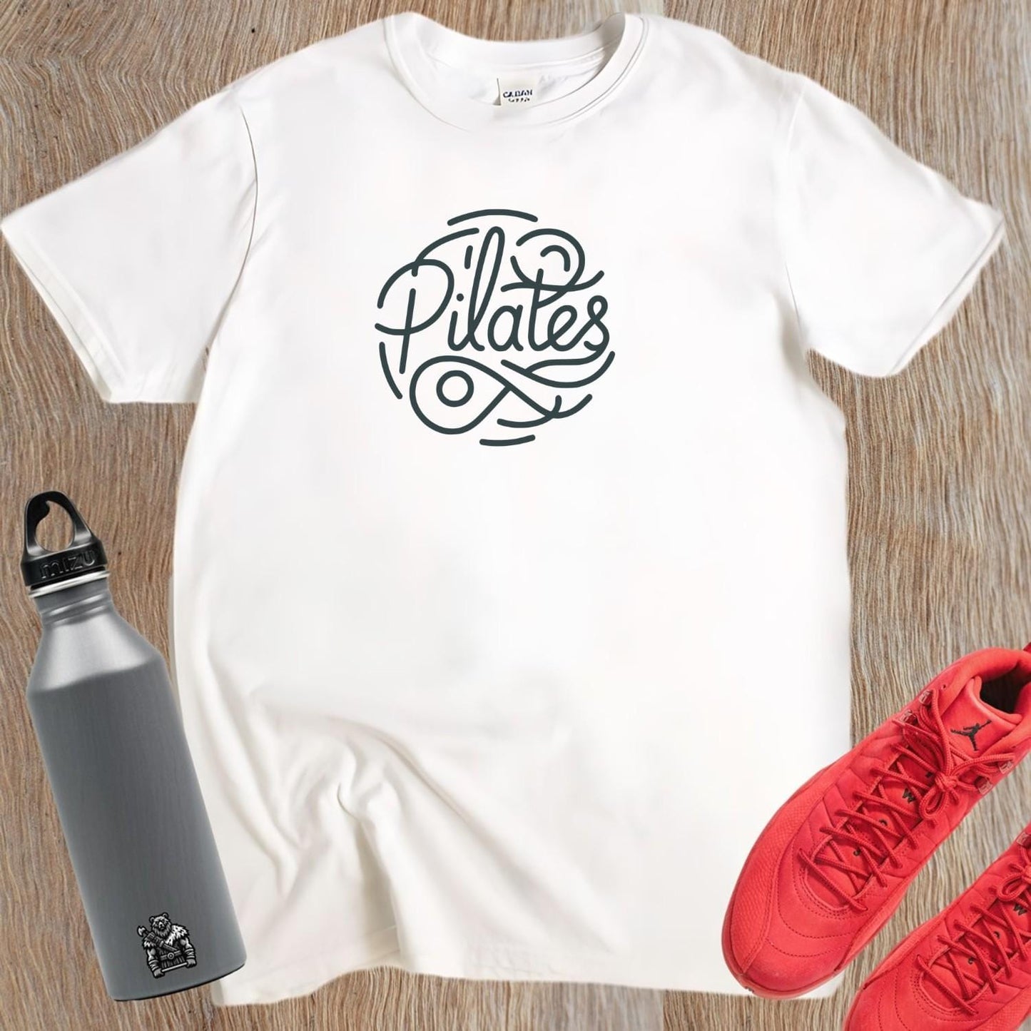 Stylish Pilates T-shirt featuring a modern logo, tailored for comfort and movement, ideal for workouts and casual outings.