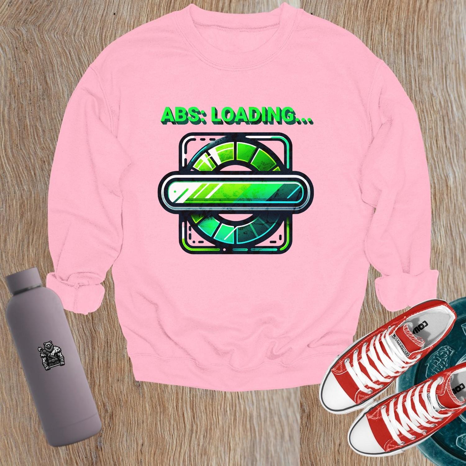 "Lightweight gray crewneck sweatshirt featuring 'ABS: LOADING...' graphic. Perfect for gym workouts and casual wear, showcasing fitness focus."