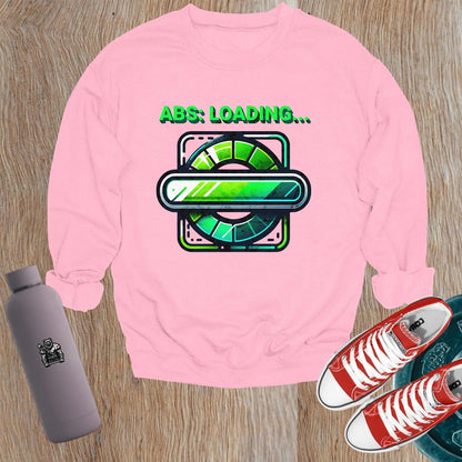"Lightweight gray crewneck sweatshirt featuring 'ABS: LOADING...' graphic. Perfect for gym workouts and casual wear, showcasing fitness focus."
