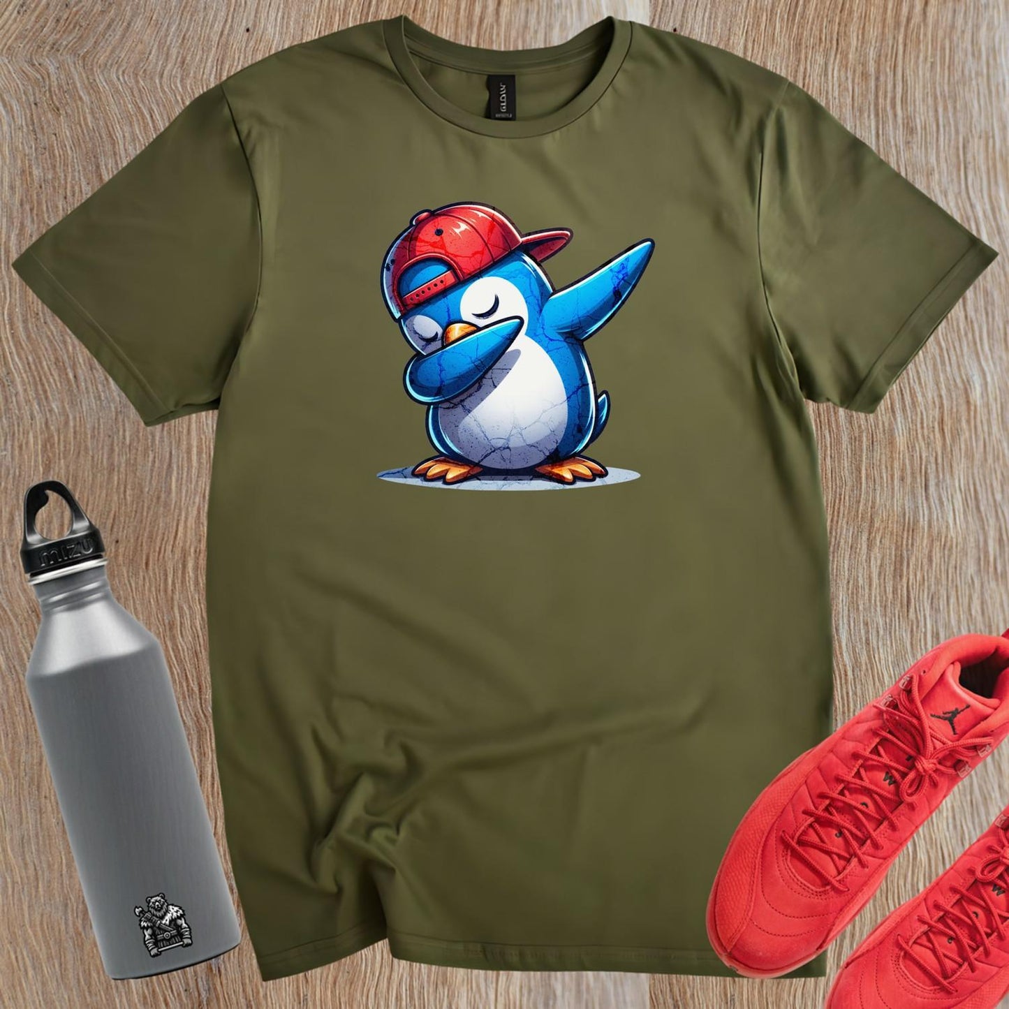 Alt text: "Vibrant gym T-shirt featuring a playful penguin wearing a cap, perfect for fitness enthusiasts who value comfort and style."