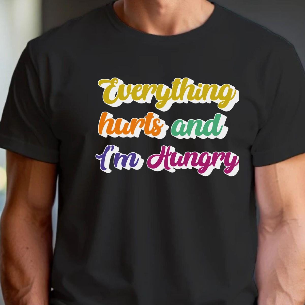 "Vibrant gym T-shirt reading 'Everything Hurts and I'm Hungry,' perfect for fitness enthusiasts who push their limits and crave results."