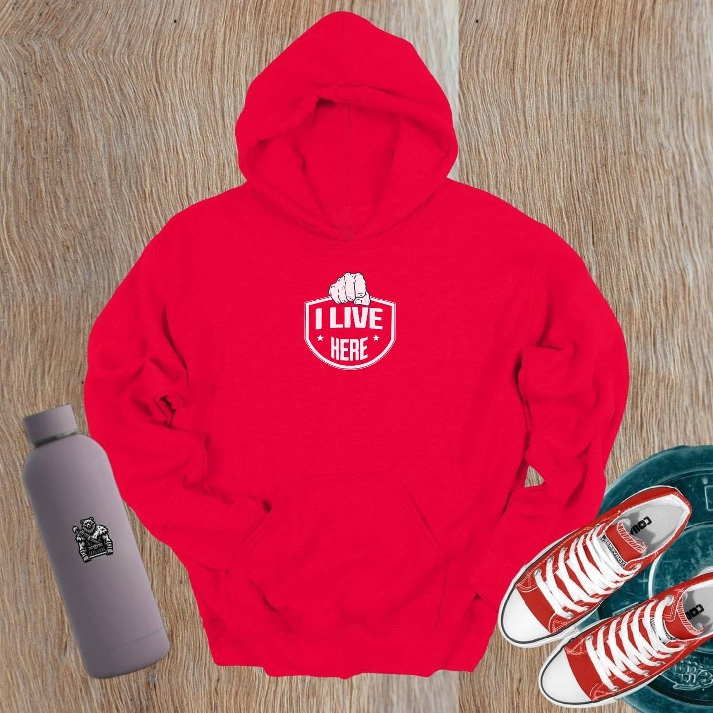 "Black gym hoodie featuring bold 'I Live Here' graphic, symbolizing strength and community. Perfect for workouts or casual wear."