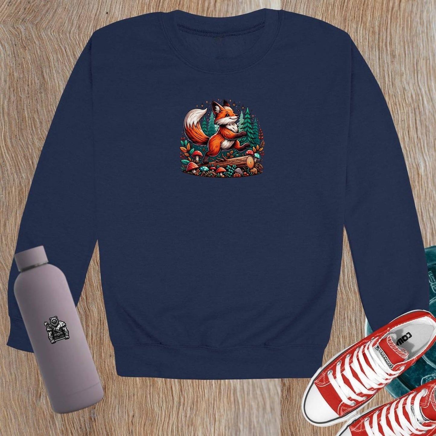 "Vibrant crewneck sweatshirt featuring a playful fox among lush trees and whimsical mushrooms, perfect for gym or casual outings."