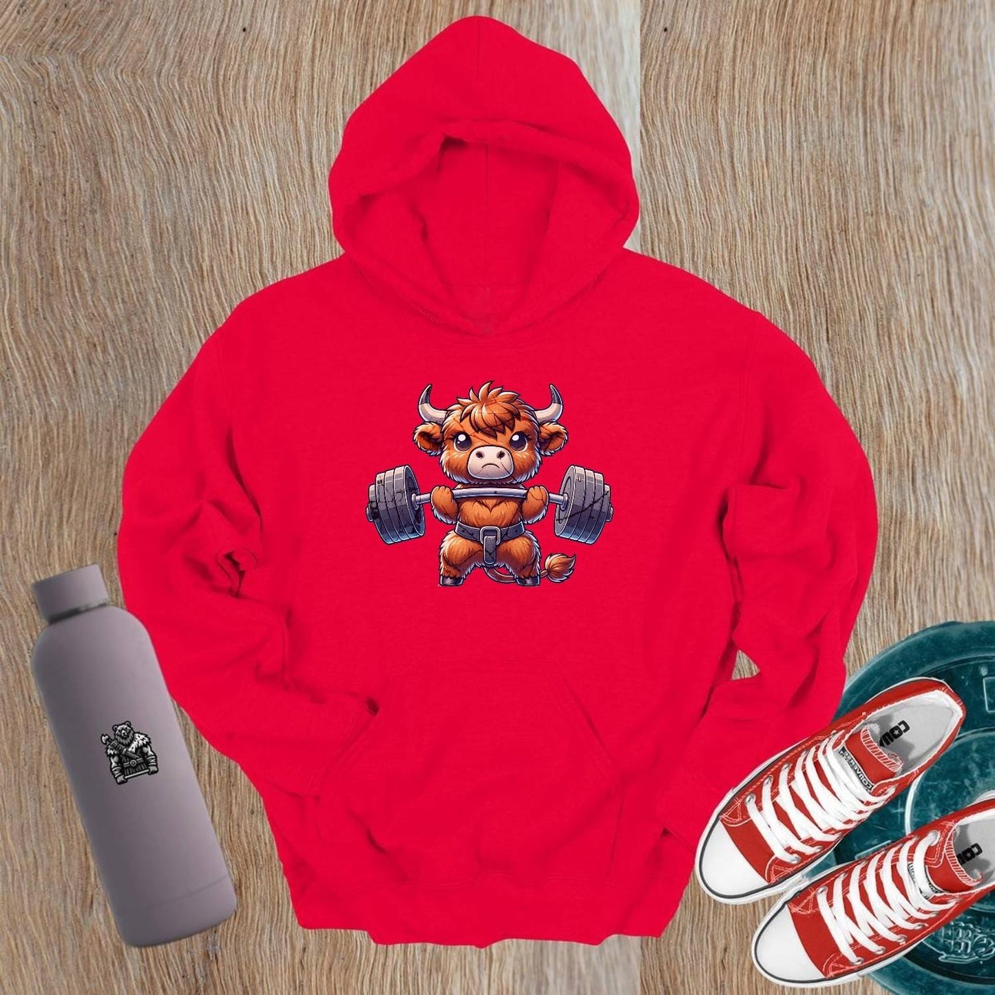"Cartoon bull lifting weights on a stylish gym hoodie, embodying strength and motivation for gym enthusiasts and fitness lovers."