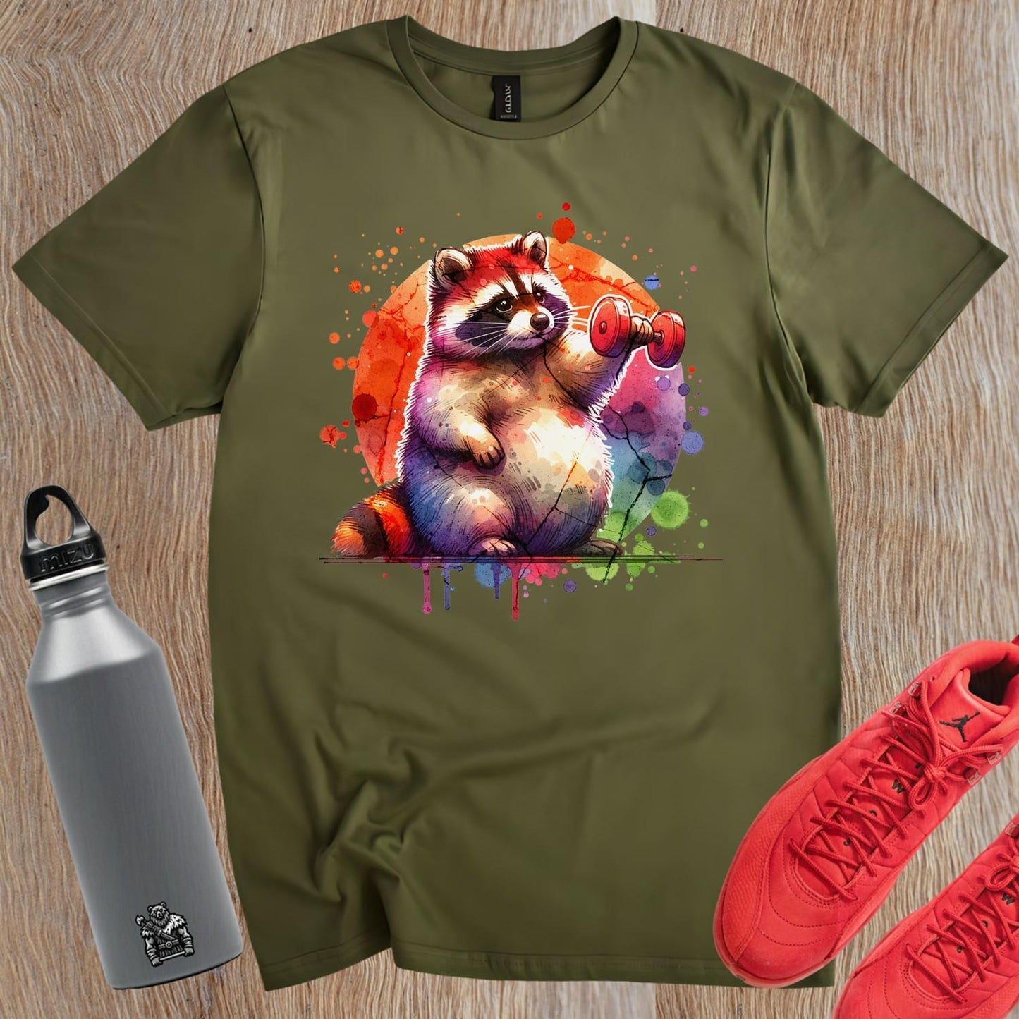 "Whimsical raccoon lifting weights on a vibrant gym T-shirt, perfect for fitness lovers and animal enthusiasts. Stylish workout attire."