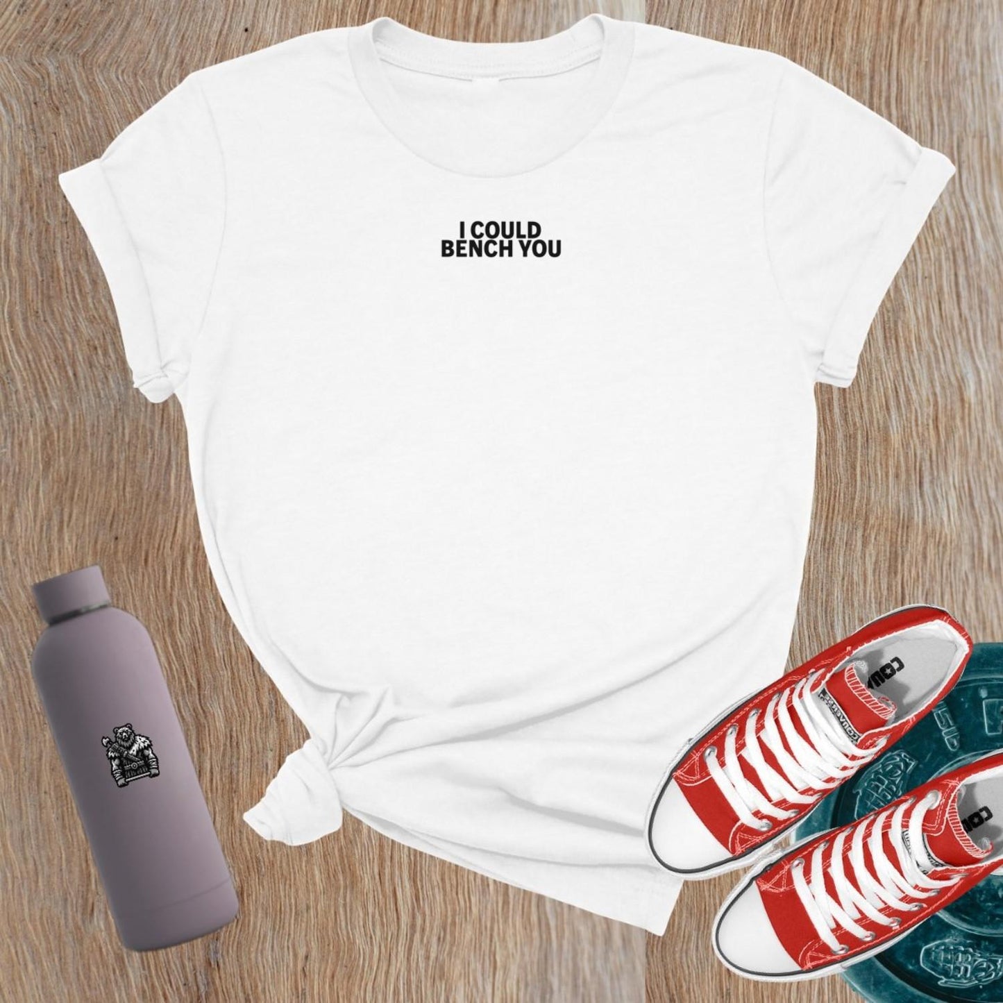 "Bold 'I Could Bench You' graphic on a flattering women's gym T-shirt, perfect for female lifters and fitness enthusiasts."