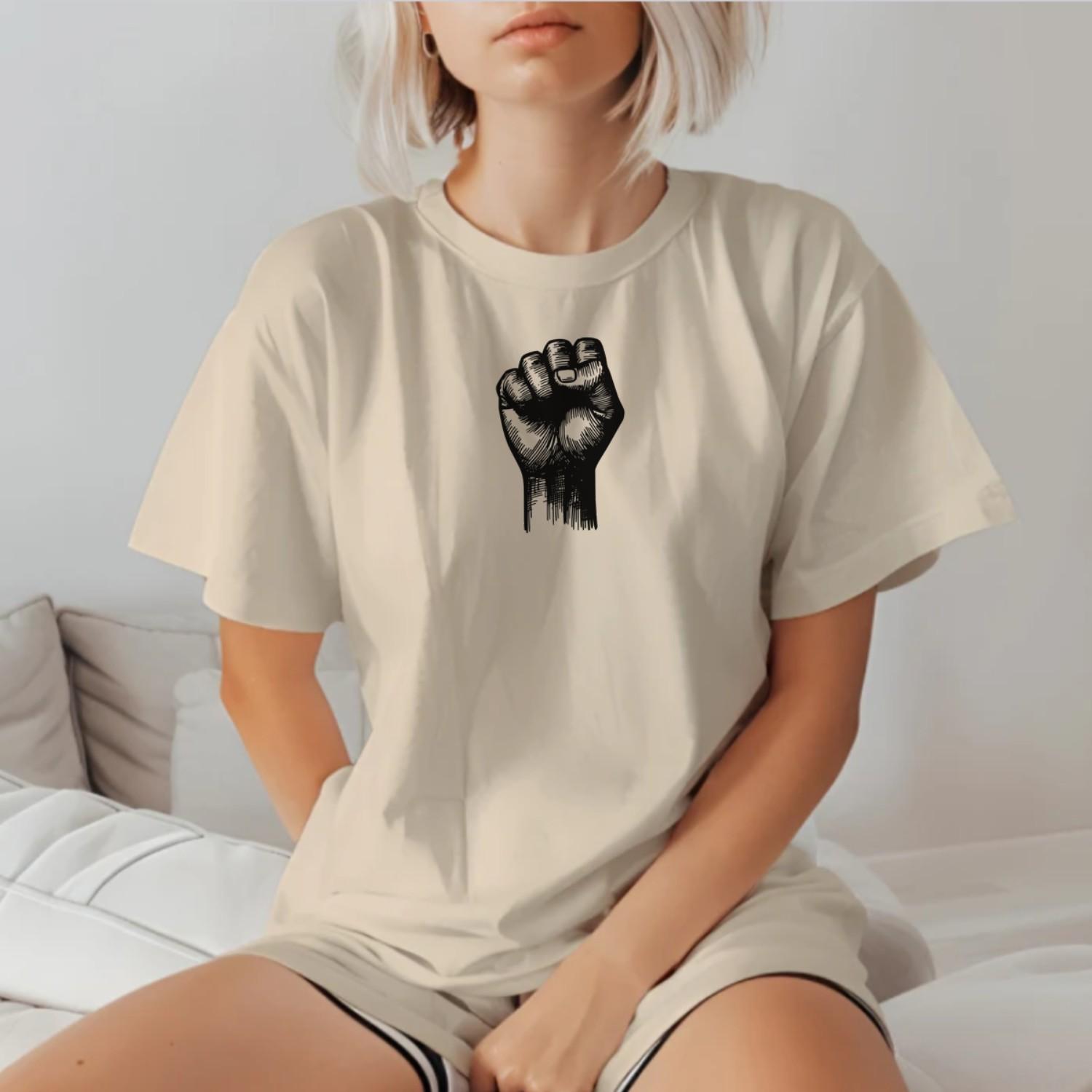 Alt text: "Bold gym t-shirt with a powerful raised fist graphic, symbolizing strength and determination for passionate fitness enthusiasts."
