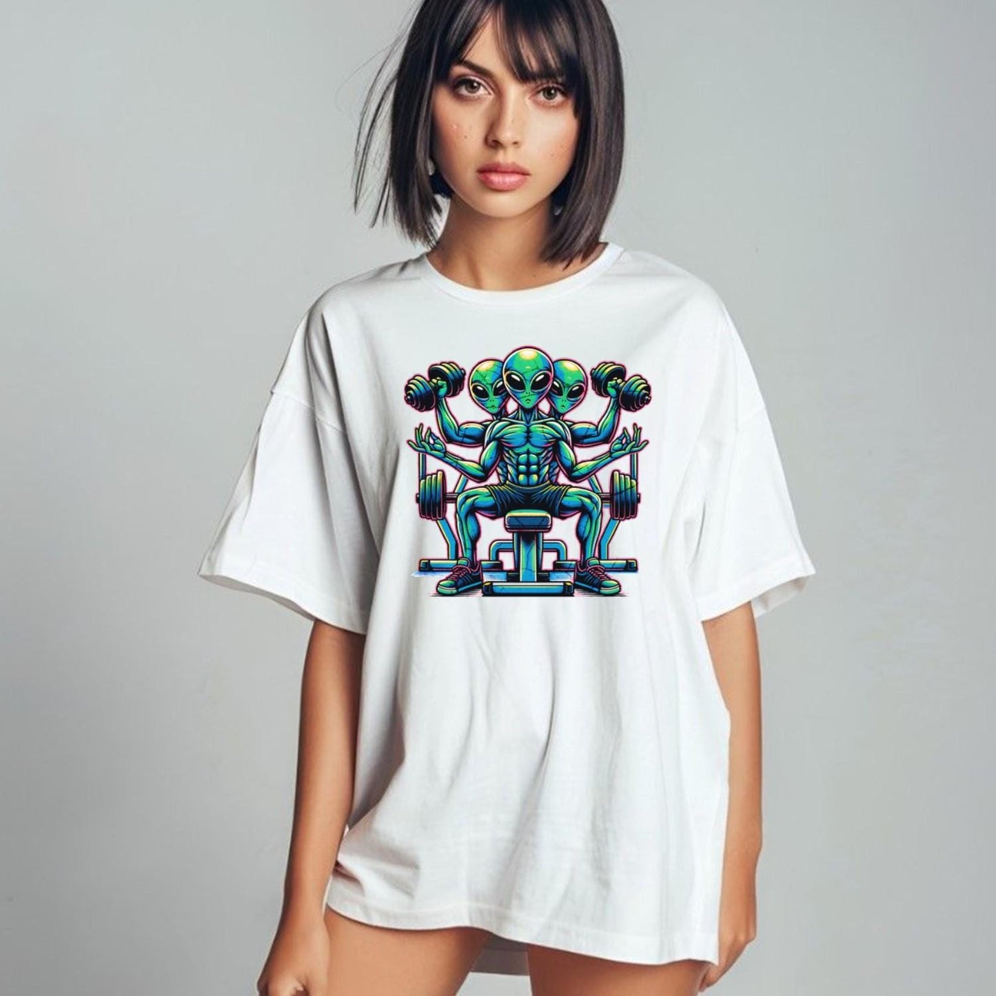 "Colorful graphic of powerful aliens lifting weights on a gym t-shirt, inspiring fitness goals and showcasing unique workout style."
